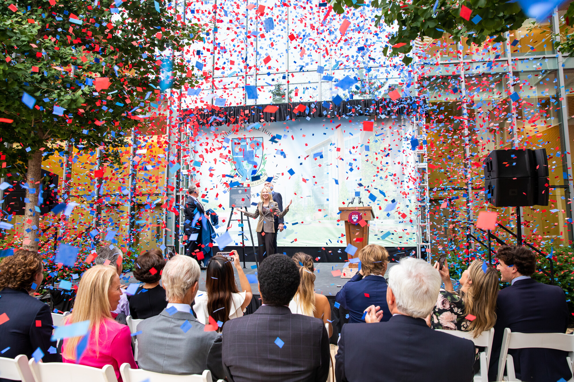 William and Ronald Lauder on stage with Amy Gutmann as confetti falls