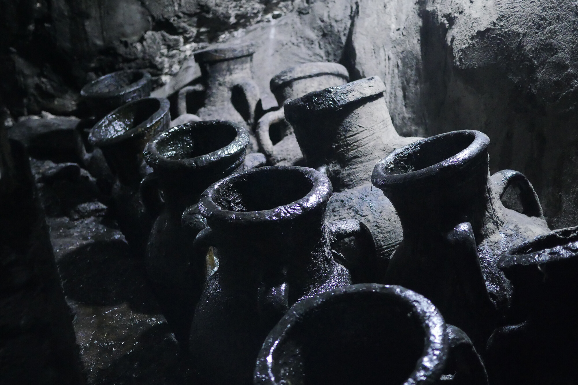 Closeup shot of 10 unearthed juglike vessels