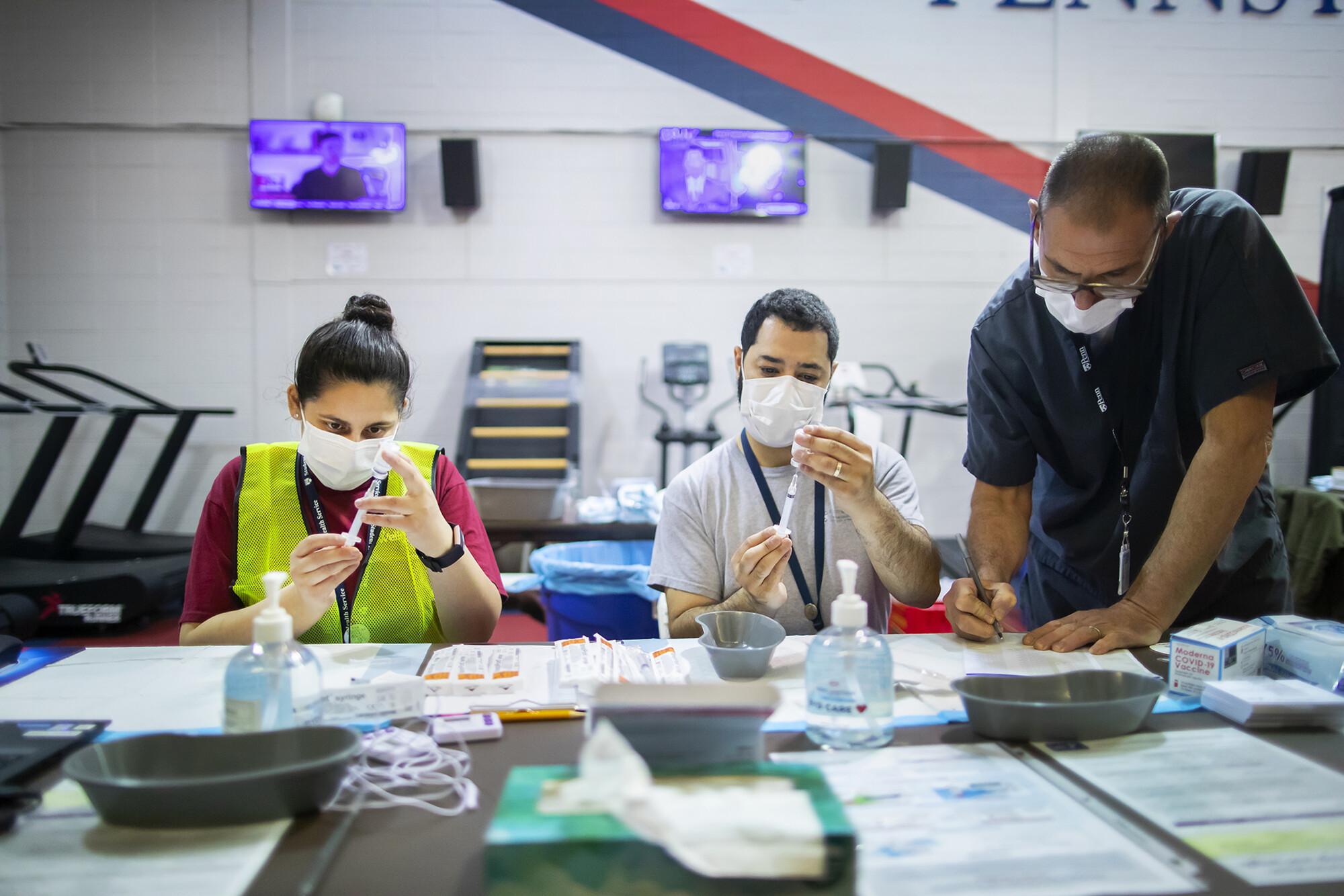 vaccine clinic workers preparing shots