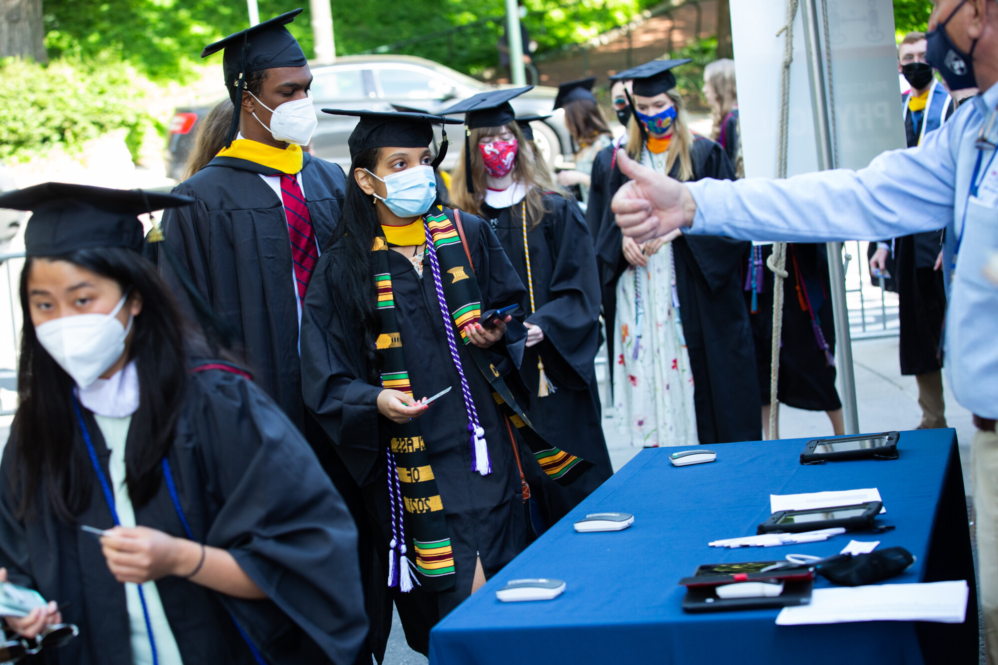 graduates checking in before entering franklin field