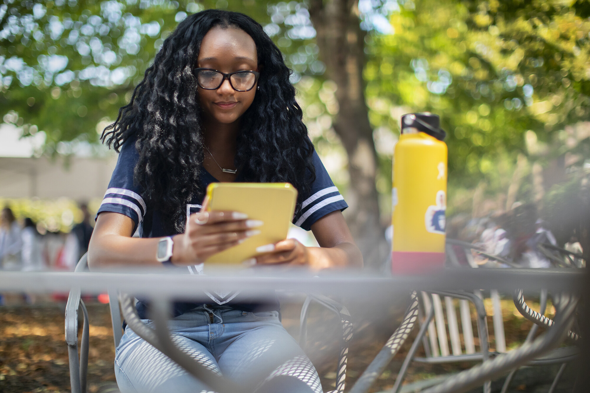 morgan bacon sitting in courtyard reading