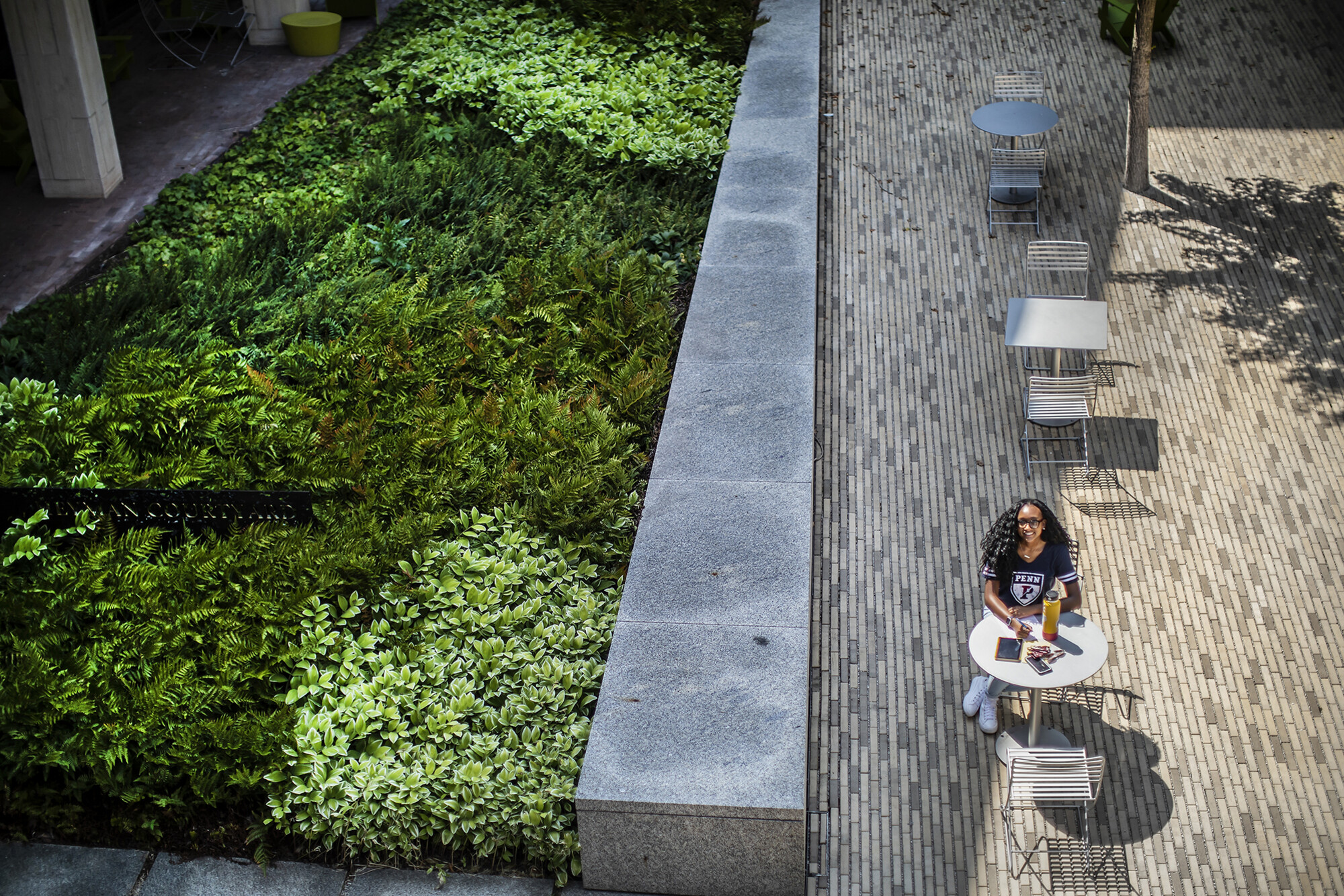 morgan sitting in the courtyard at a table