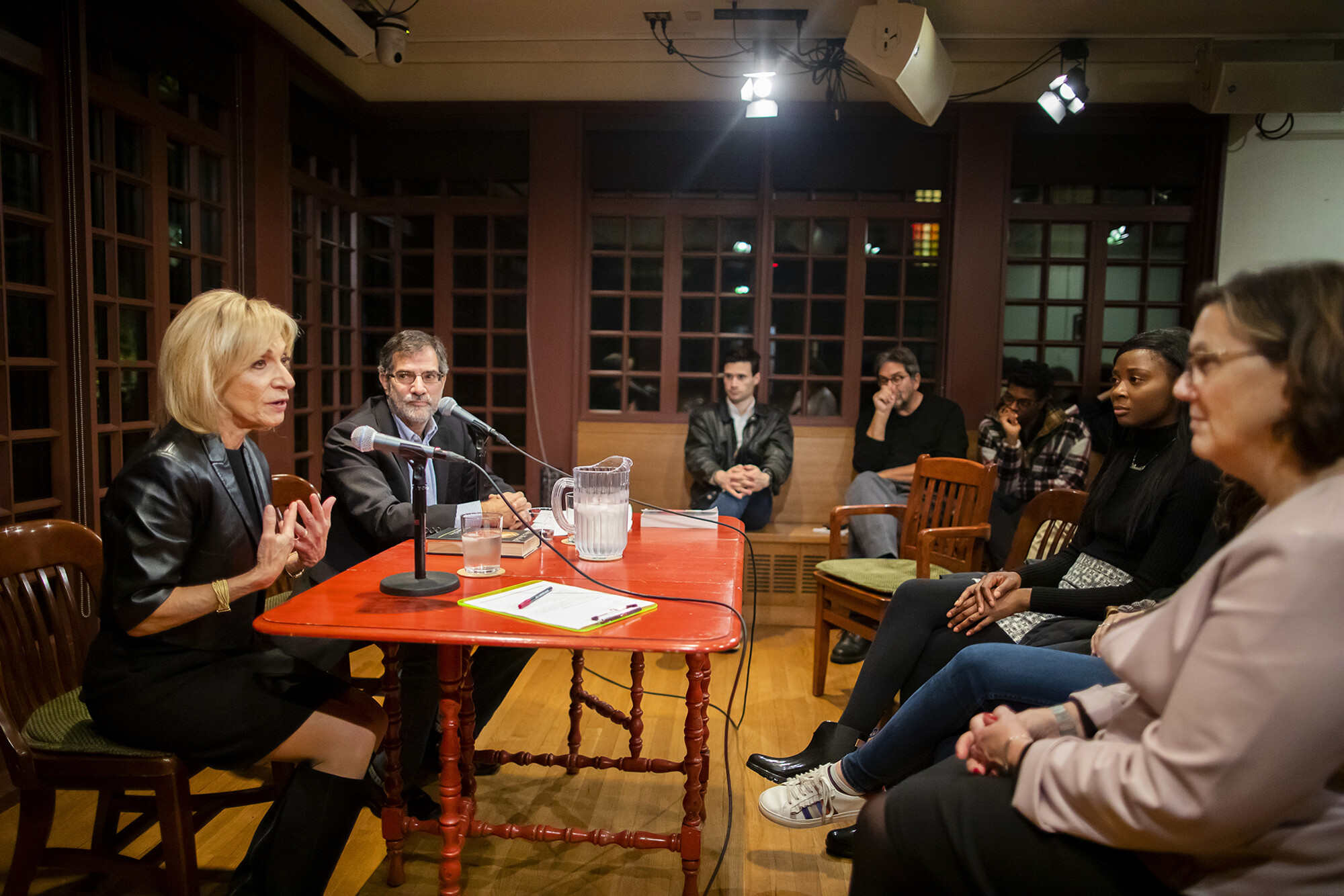 Andrea Mitchell and Al Filreis seated at a table talking to a crowd at the Kelly Writers House.