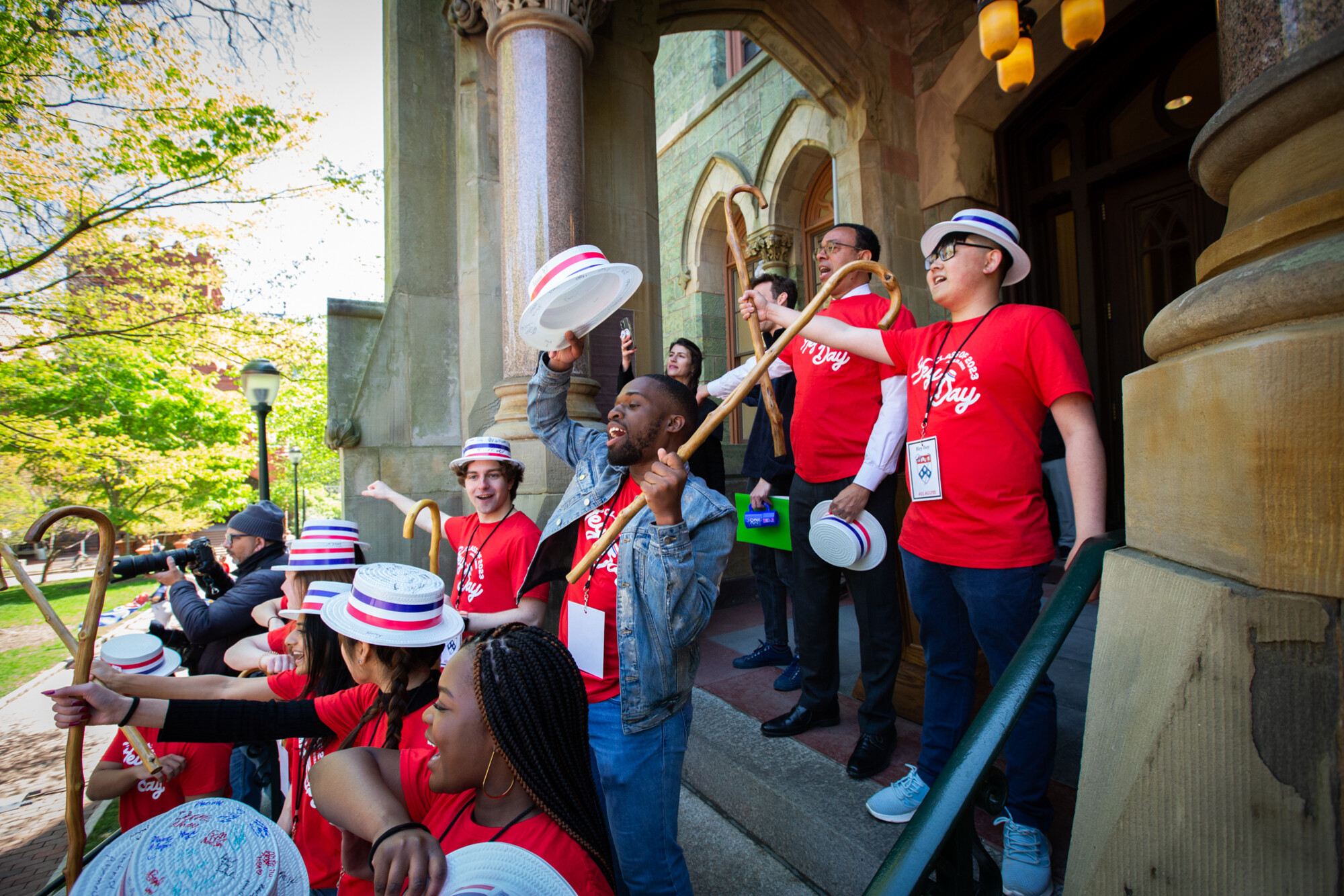 students on college hall steps singing red and blue