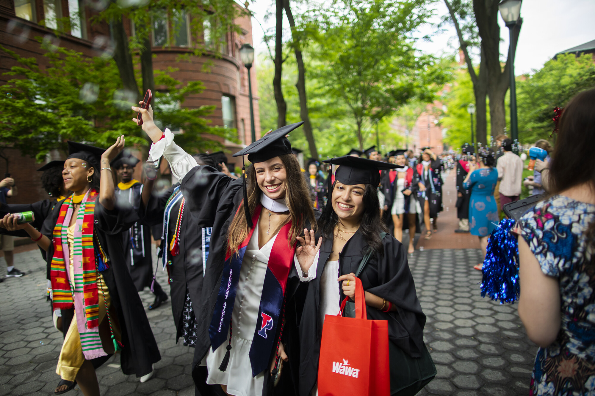 graduates walking down smith walk during commencement