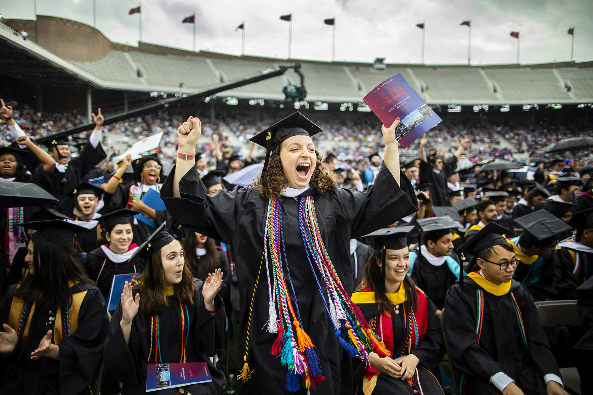 penn graduate standing up cheering