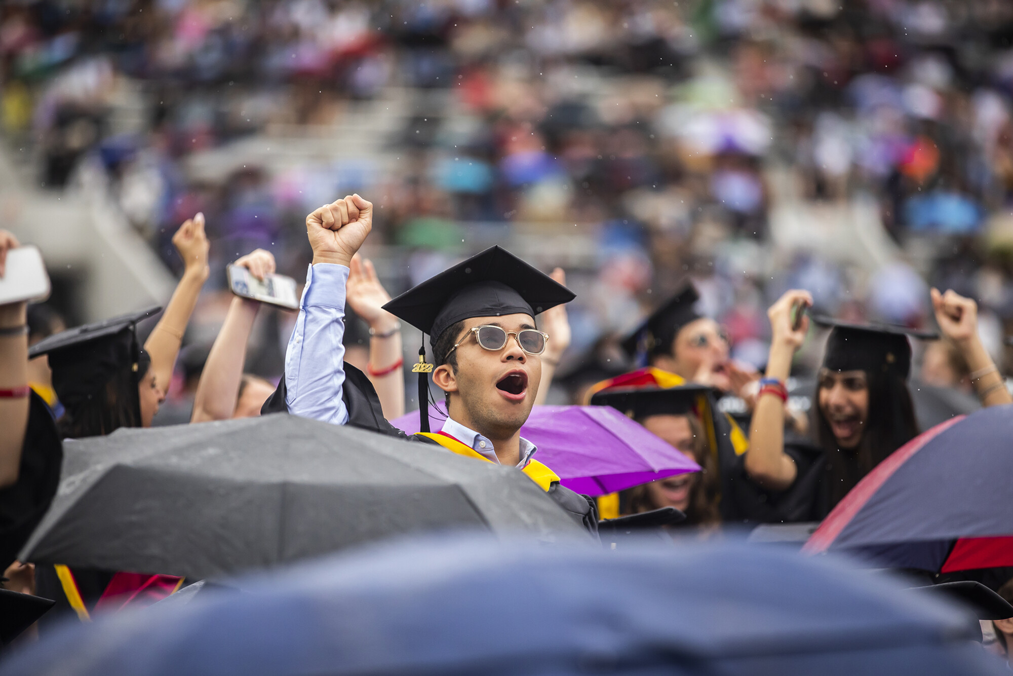 students celebrate at franklin field as the rain starts