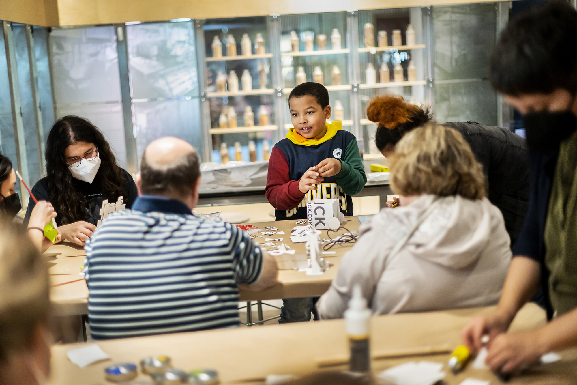 Samir Patterson (center) at a table with adults at an Ecotopian Toolkit workshop.
