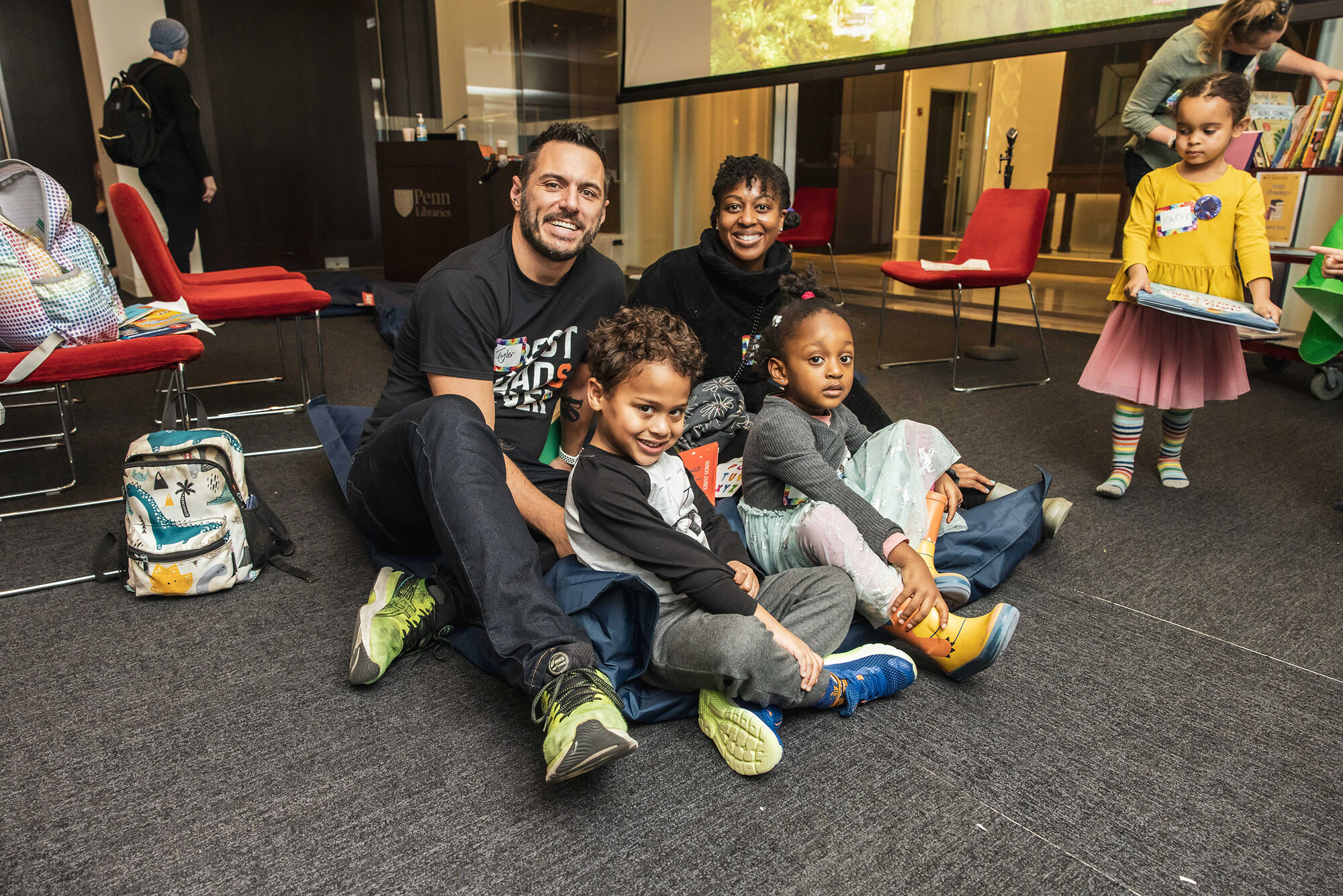 Two adults and two children smile for photo