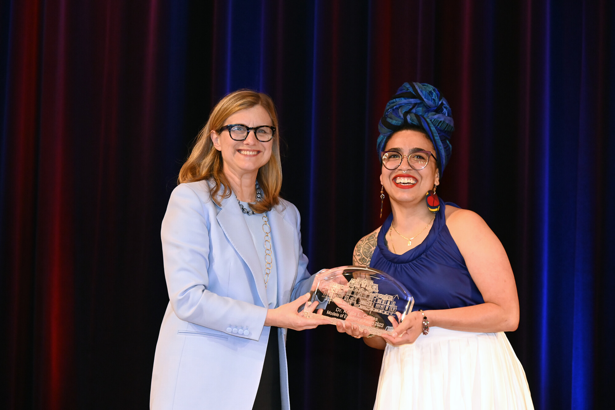 Liz Magill on stage at the Models of Excellence ceremony with Cortes.