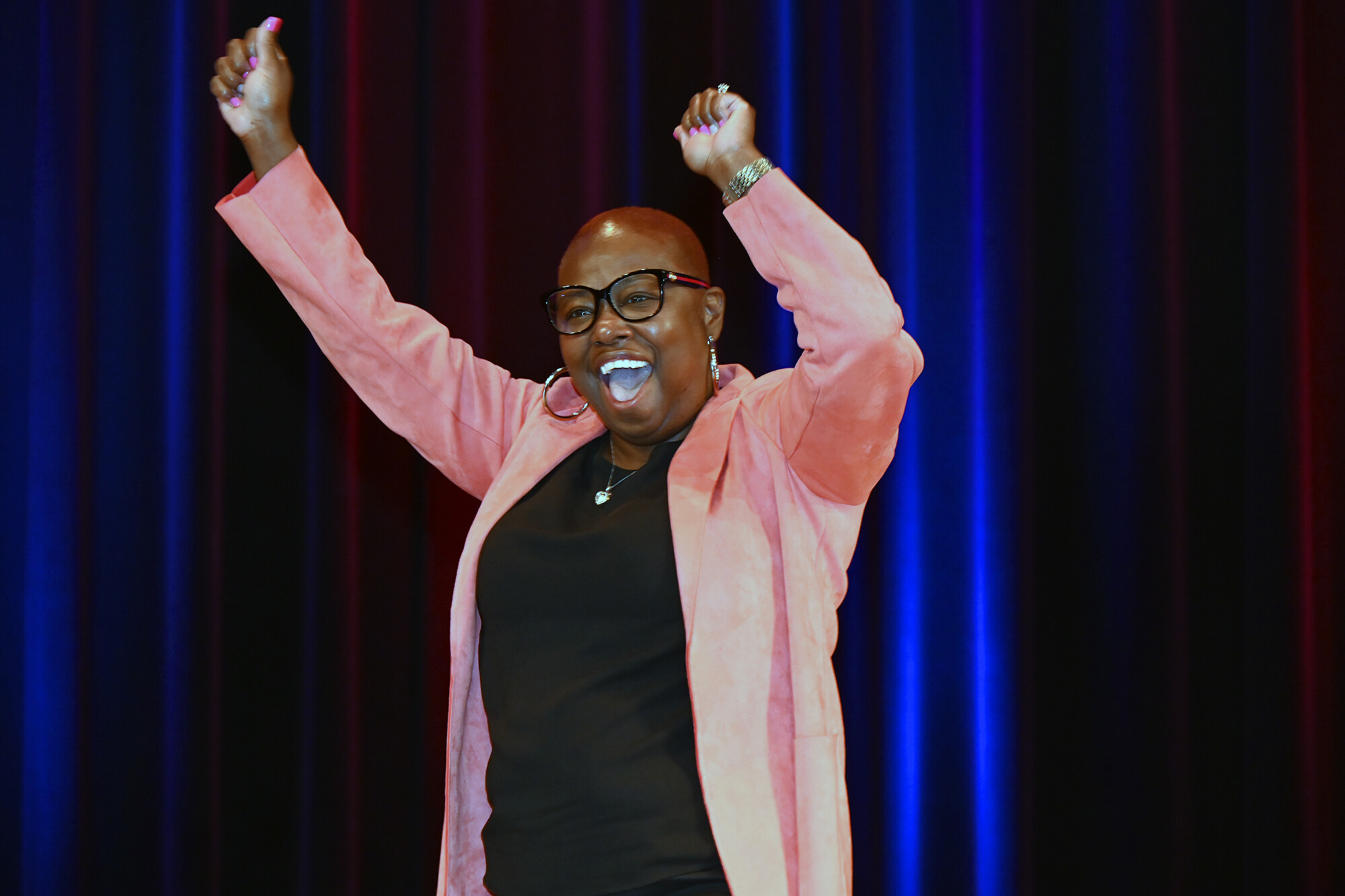 Shabazz Evans cheers on stage.
