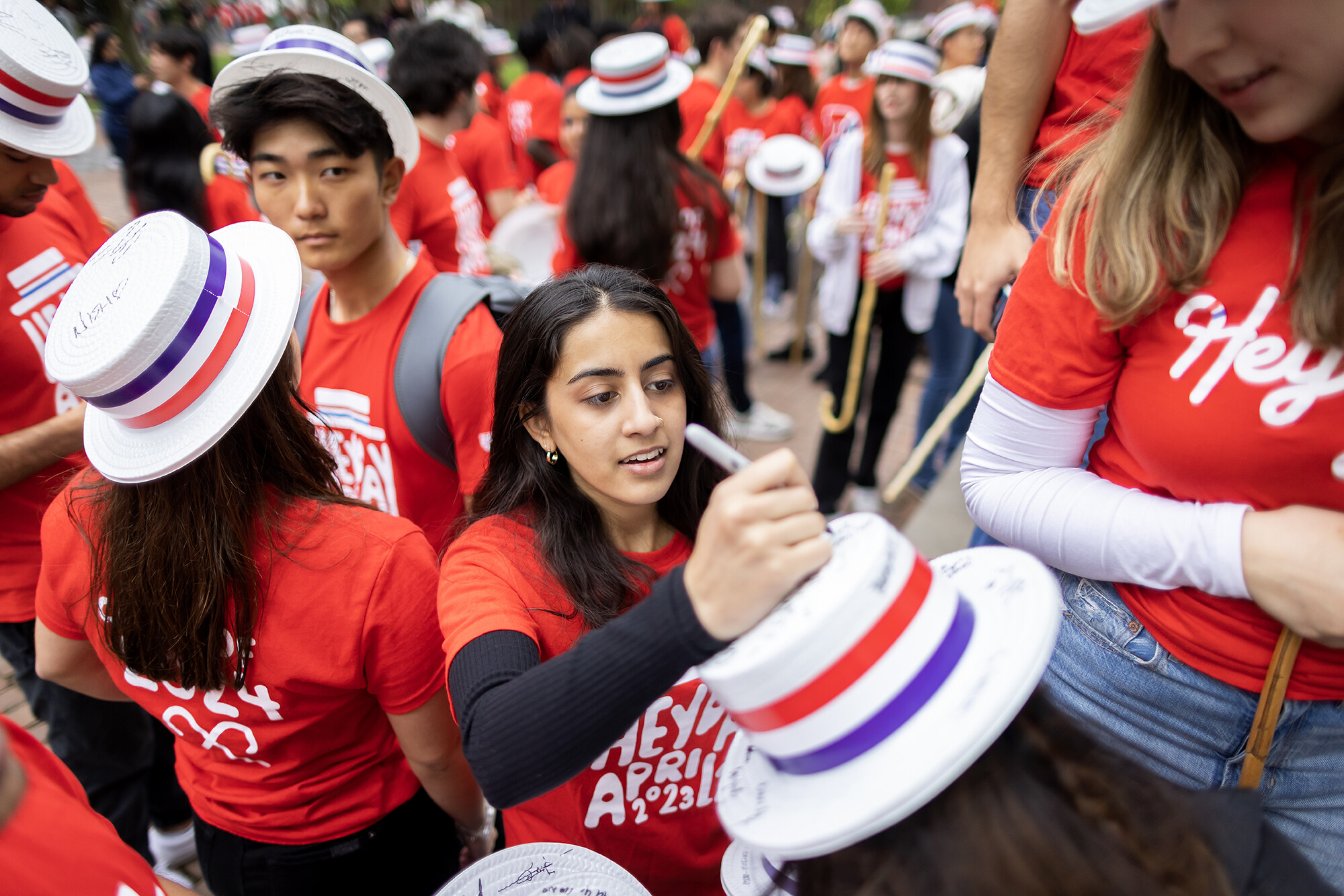 students at hey day sign each others hats
