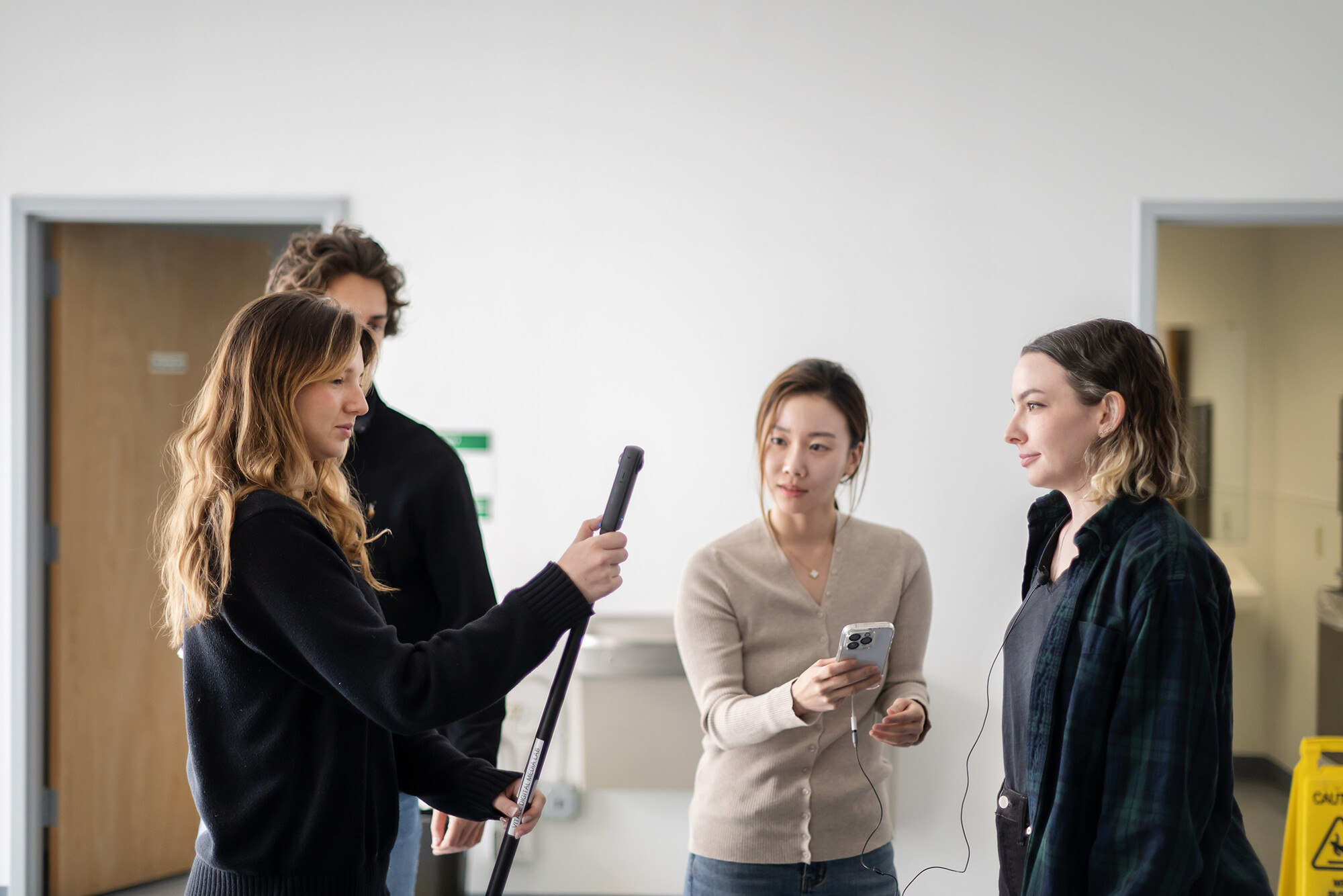 Four students test recording equipment for a VR class in the Penn Museum.