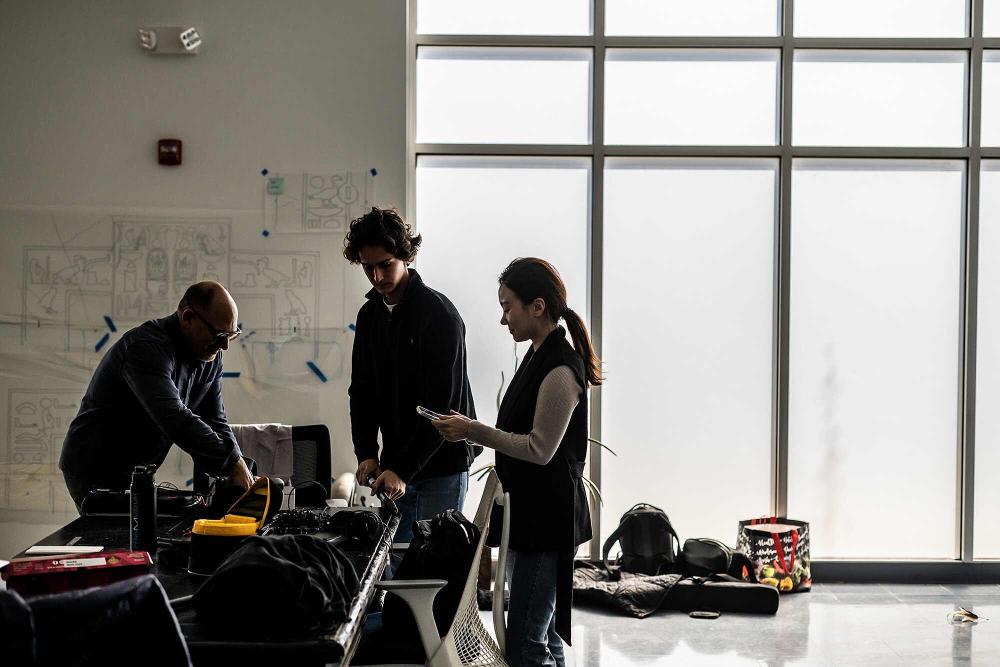 Three people in the Museum warehouse working on a VR project.