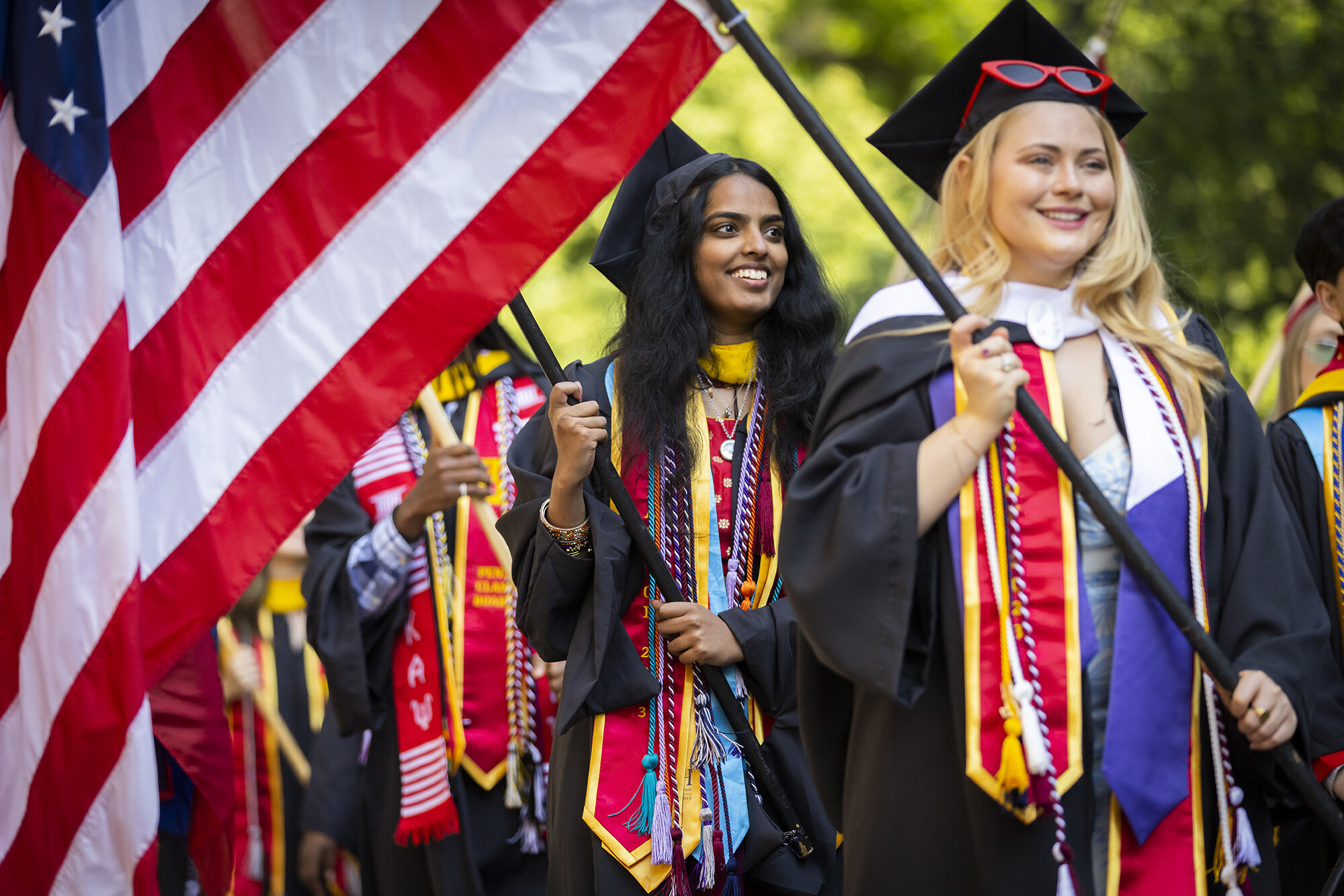 students walking the flags into franklin field during commencement