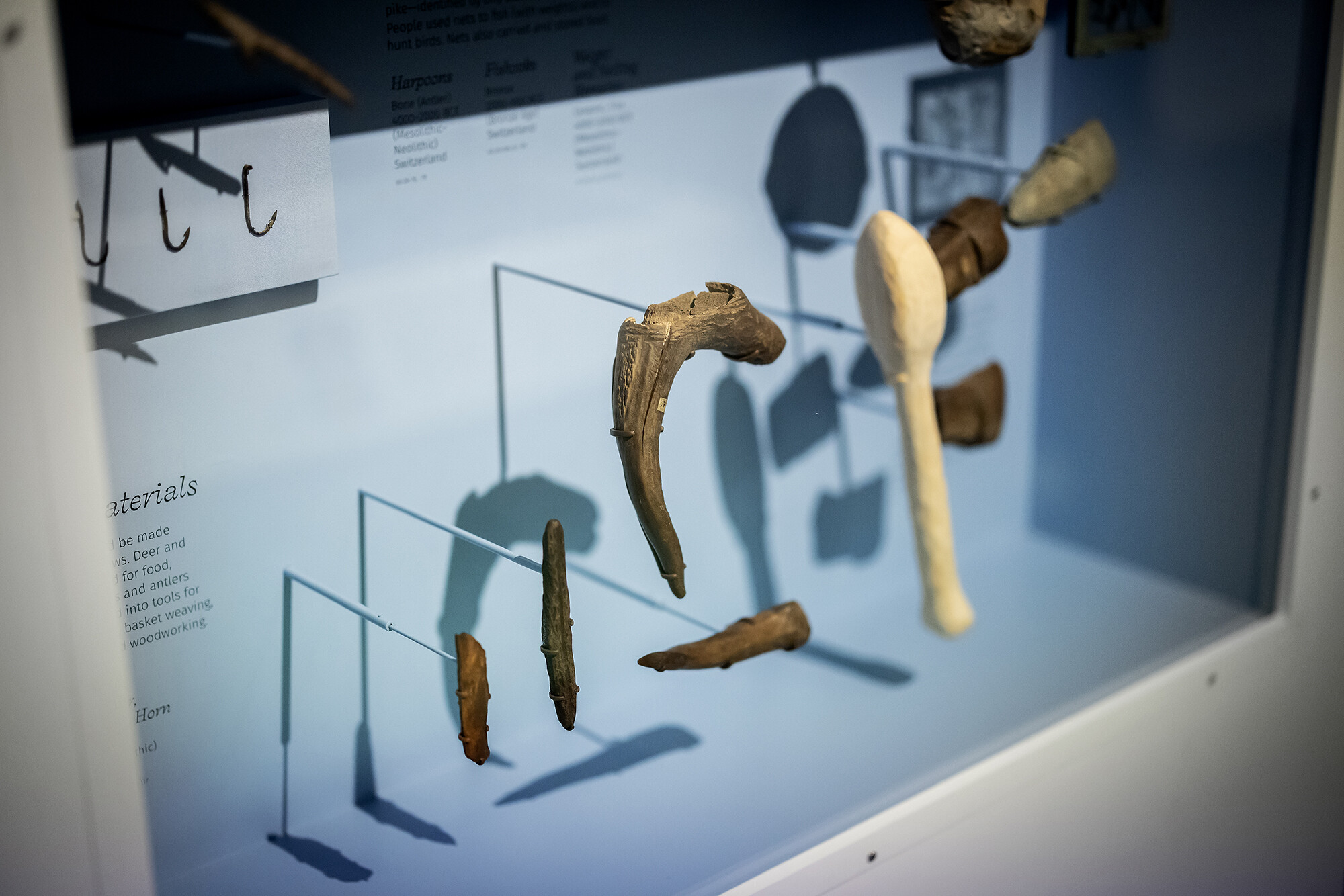 handmade wooden tools in a museum display case 