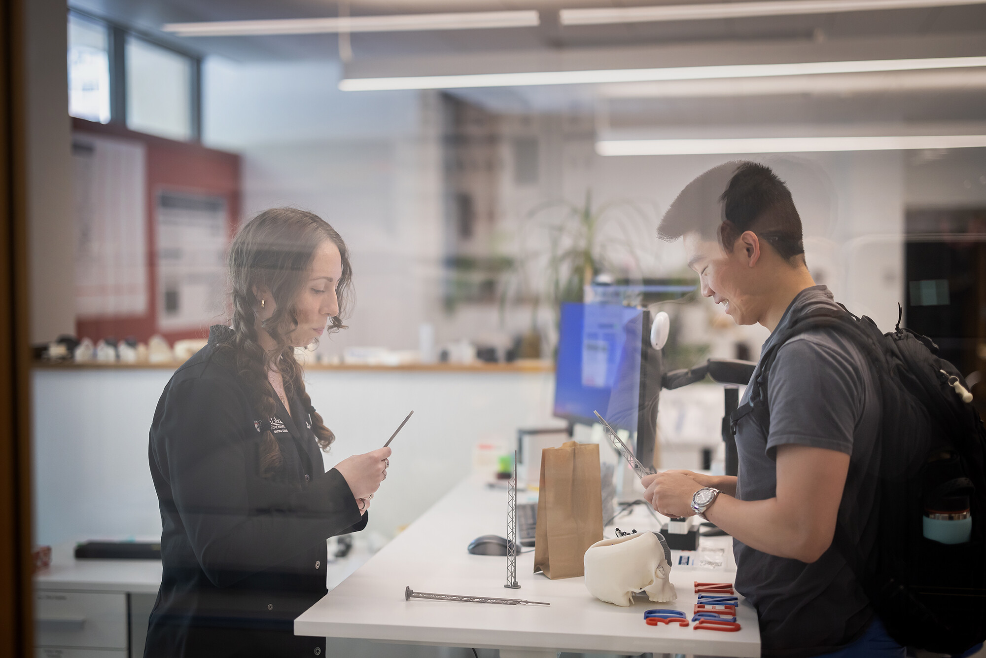 biotech commons staff helps a student at the customer service counter