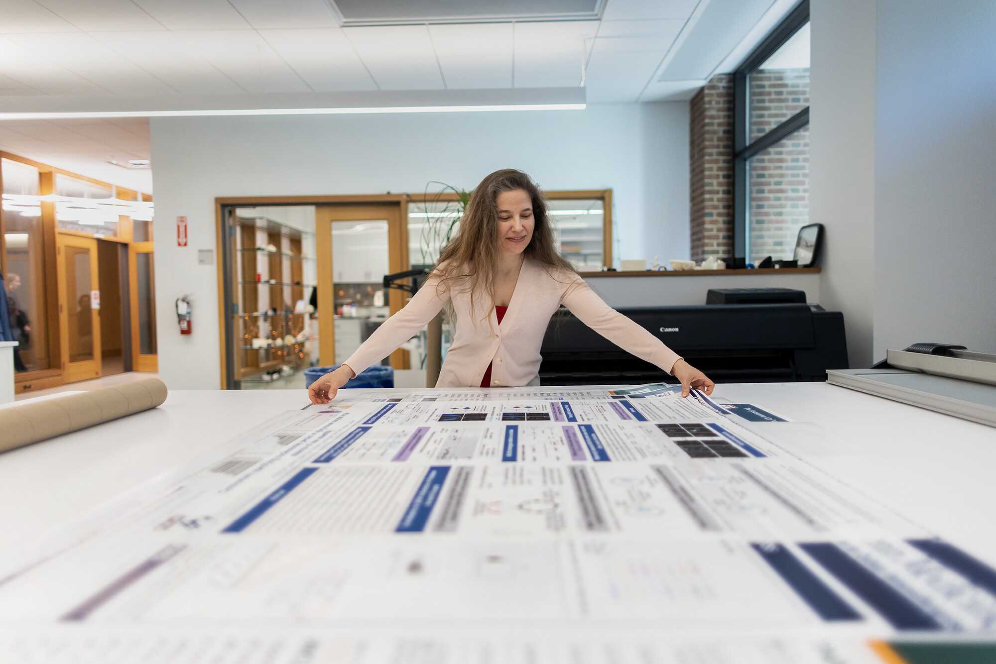 biotech commons staff works with a poster that was printed