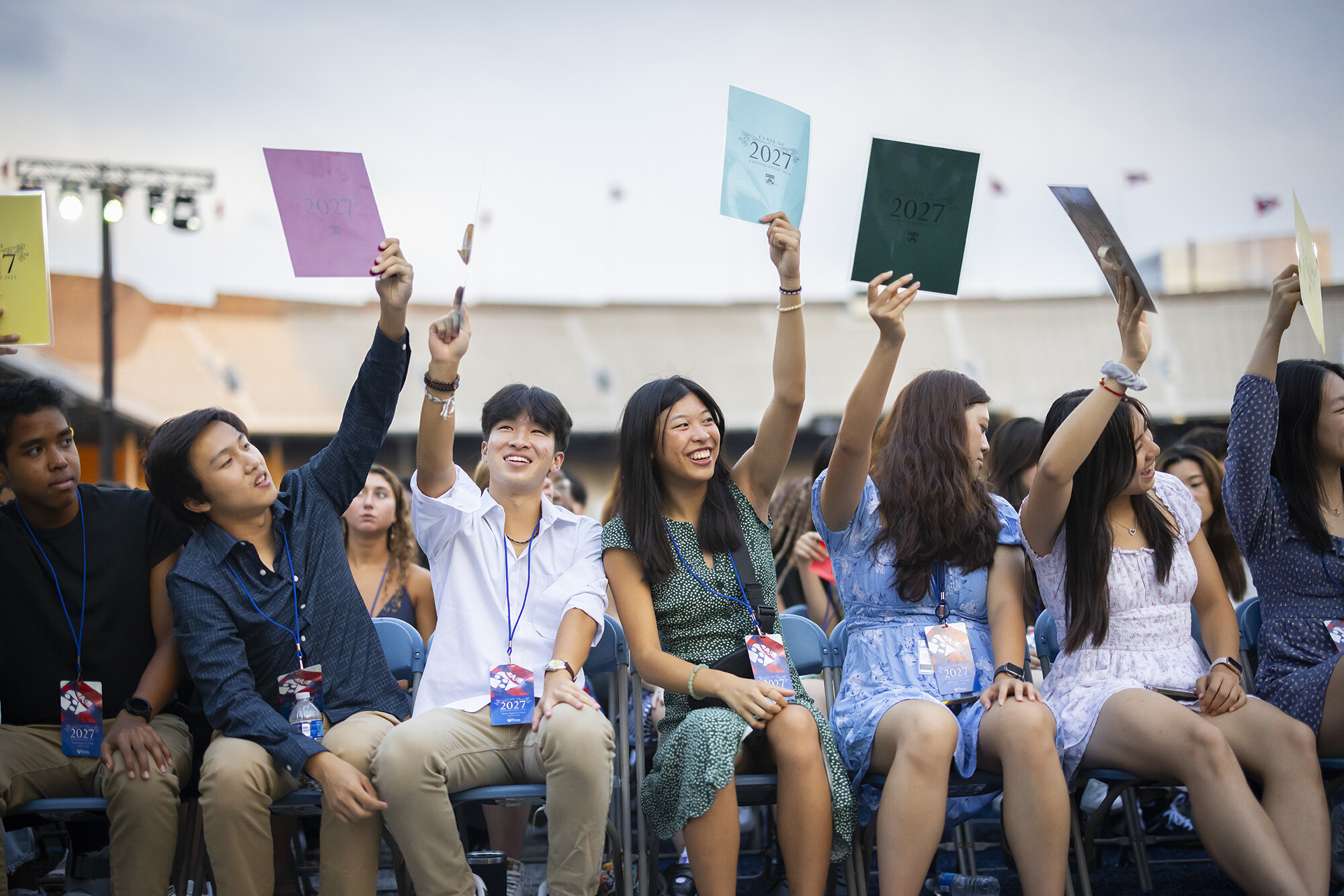 student raise signs during convocation 2023