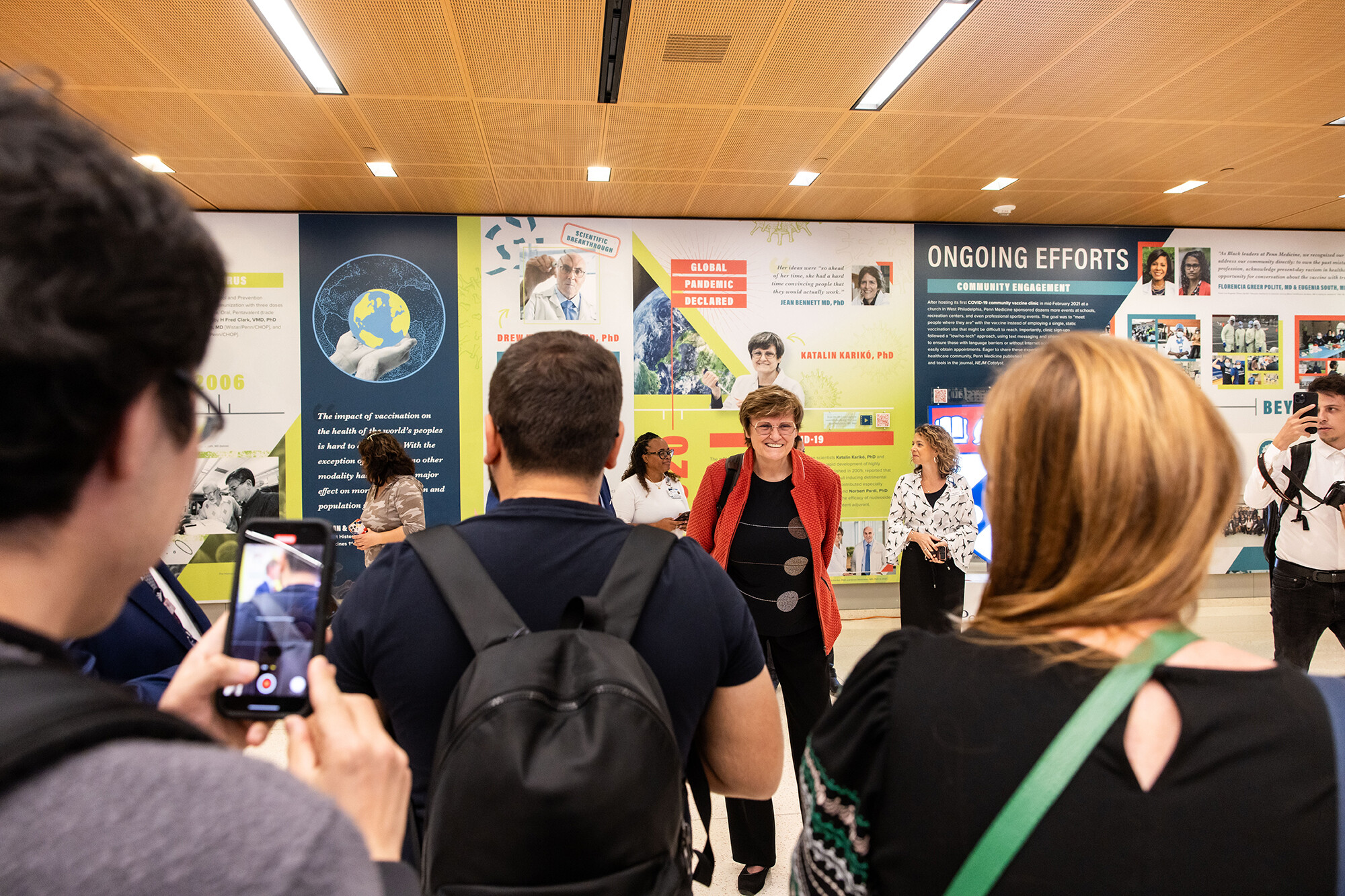 Katalin Kariko stands and has her photo taken at the Penn Medicine flash mob.
