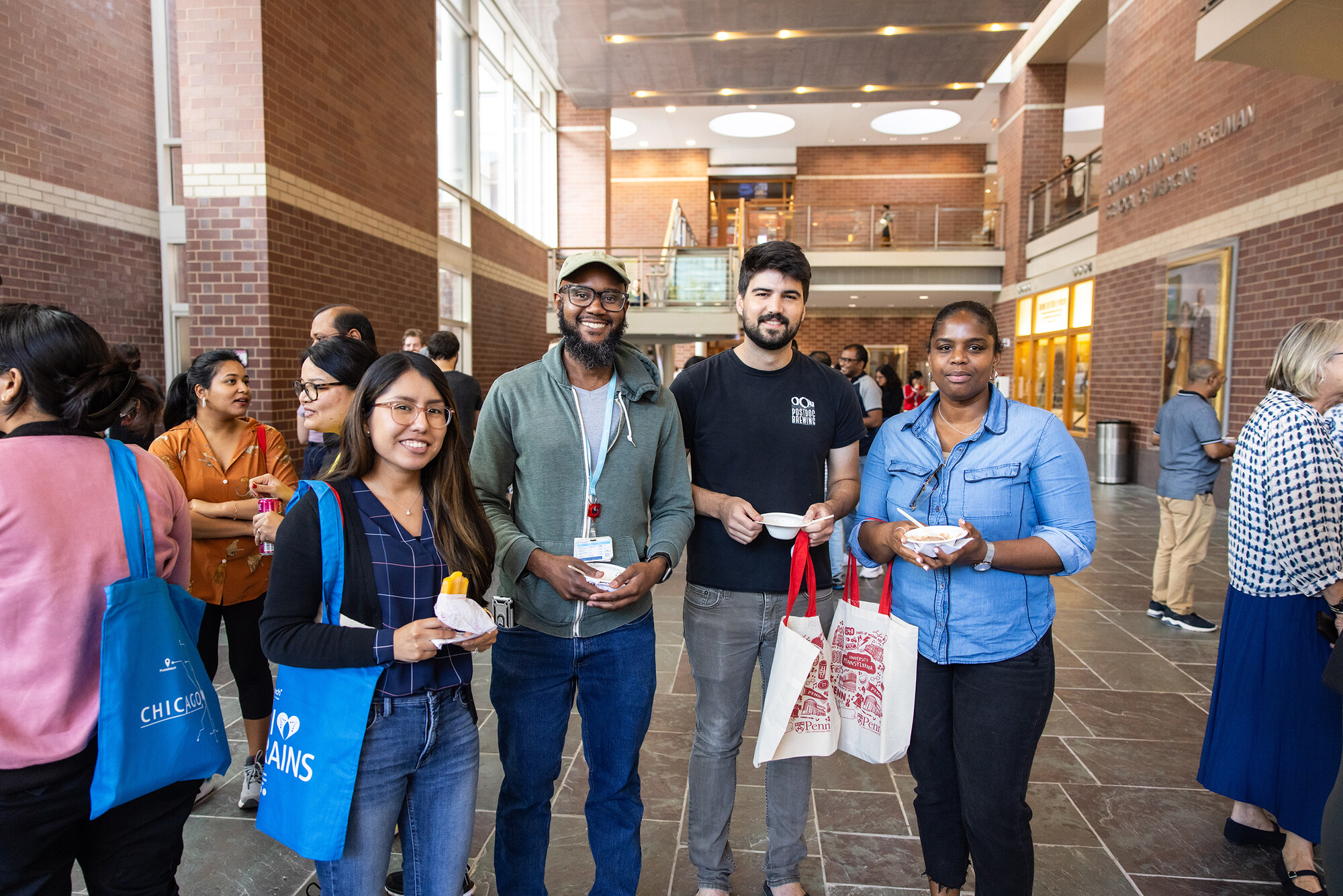 four postdocs with ice cream pose for photo