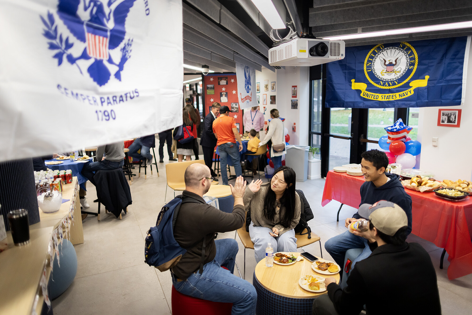 two student high-five during a veterans day lunch