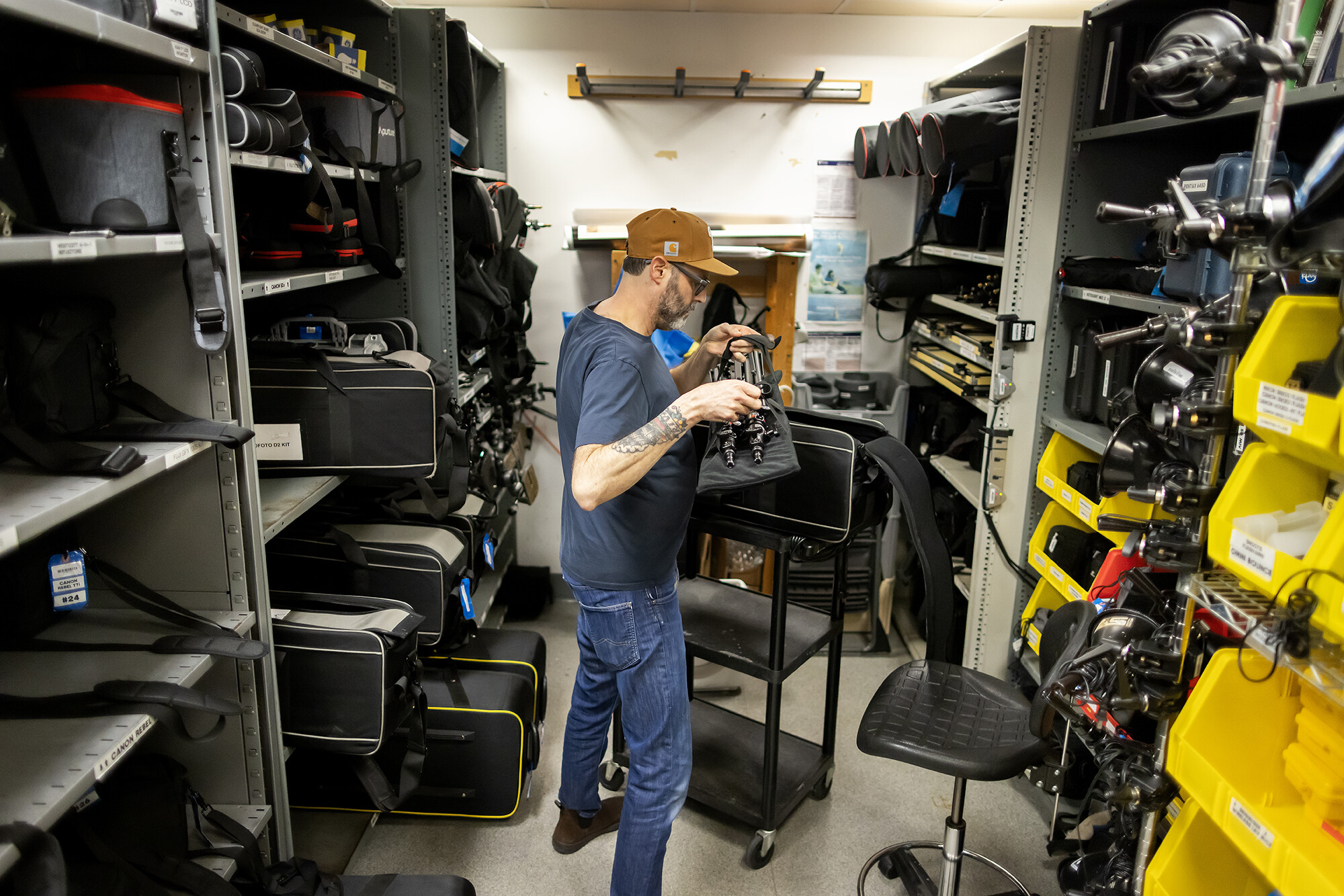 staff member working in the photography equipment cage