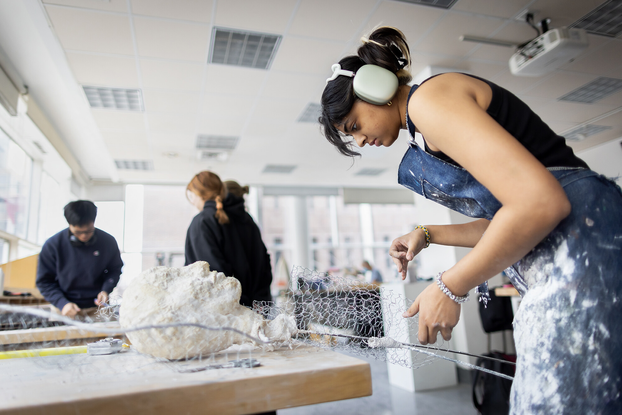 student working with sculpture materials