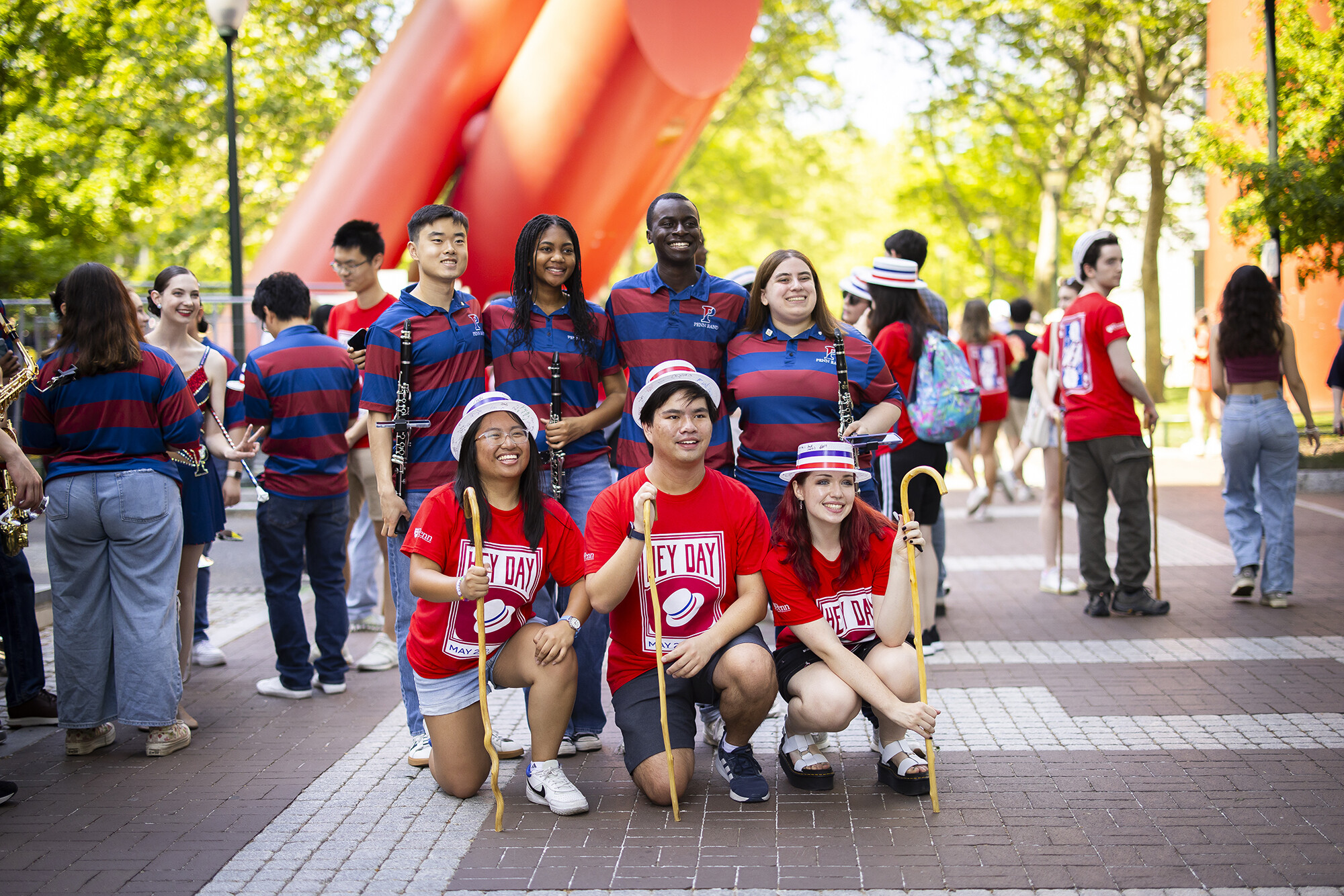 student pose in front of the covenant statue on locust walk