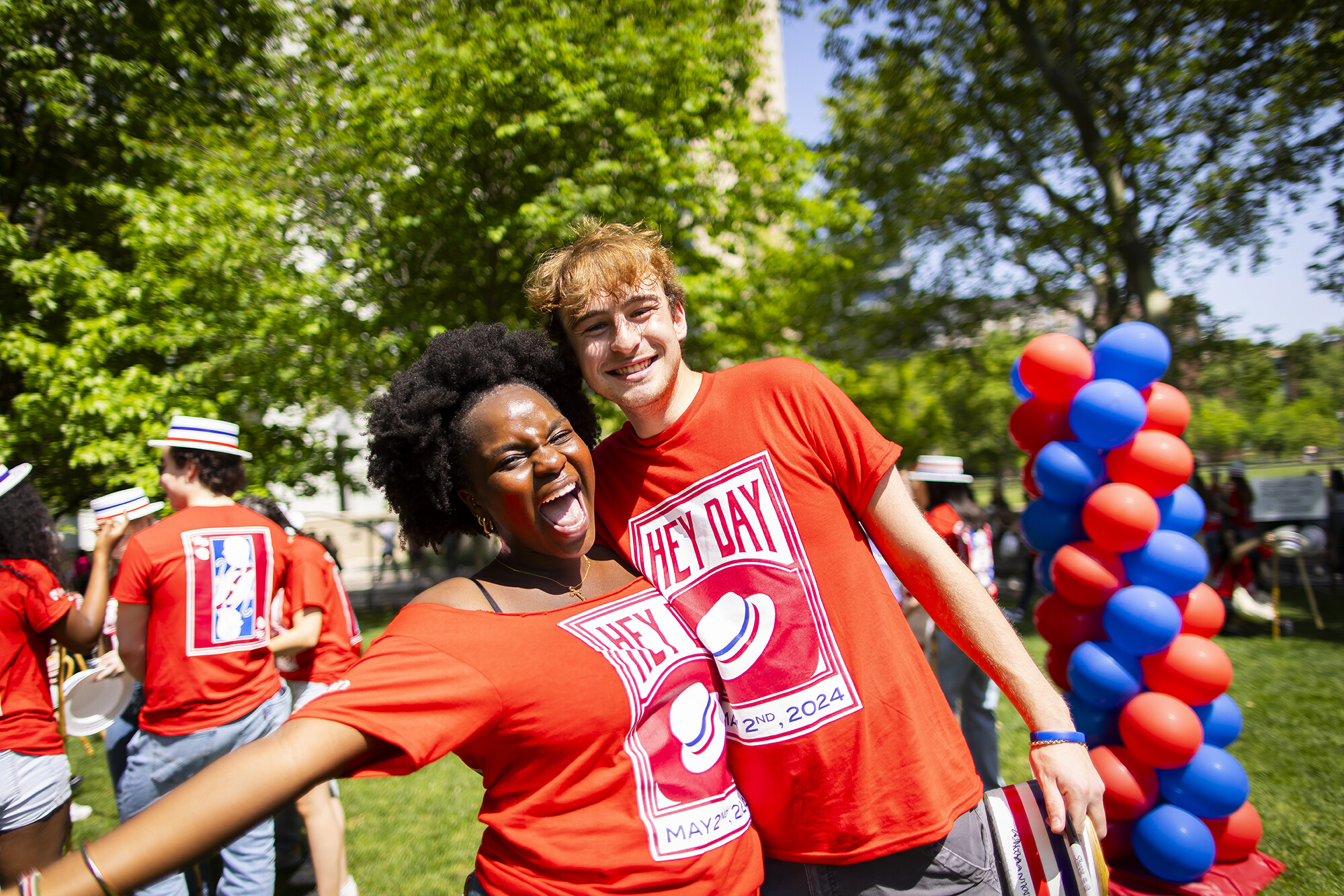 two students celebrating on high rise field during hey day