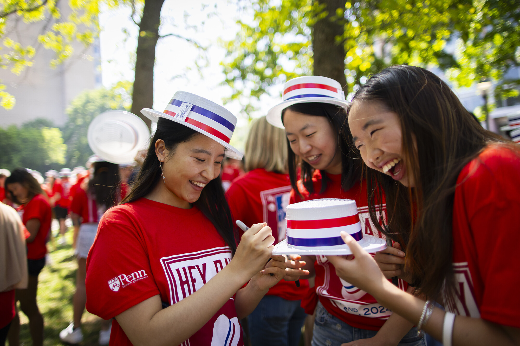students sign hats at hey day