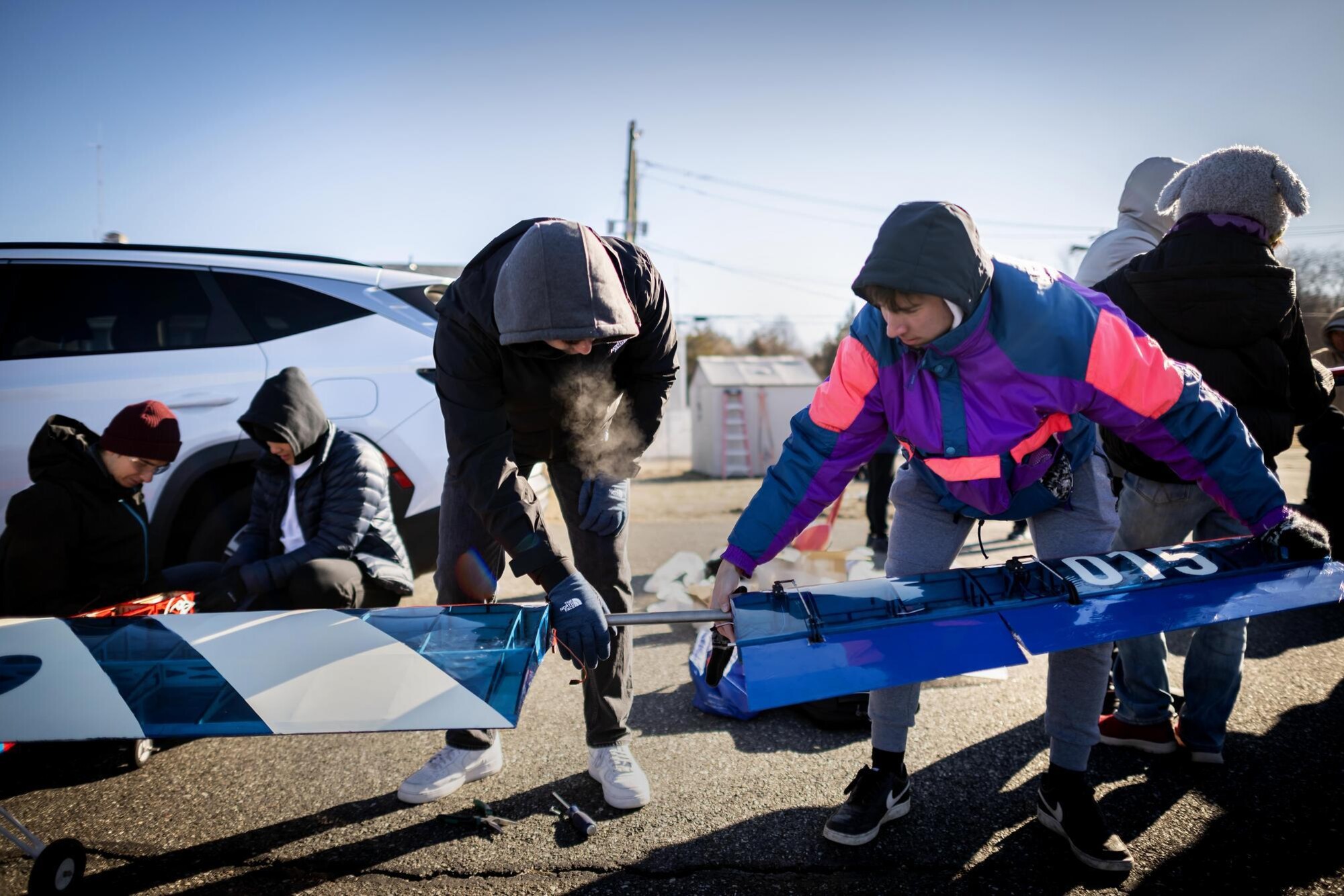 Students attaching the wings of Penn’s aerial drone plane.
