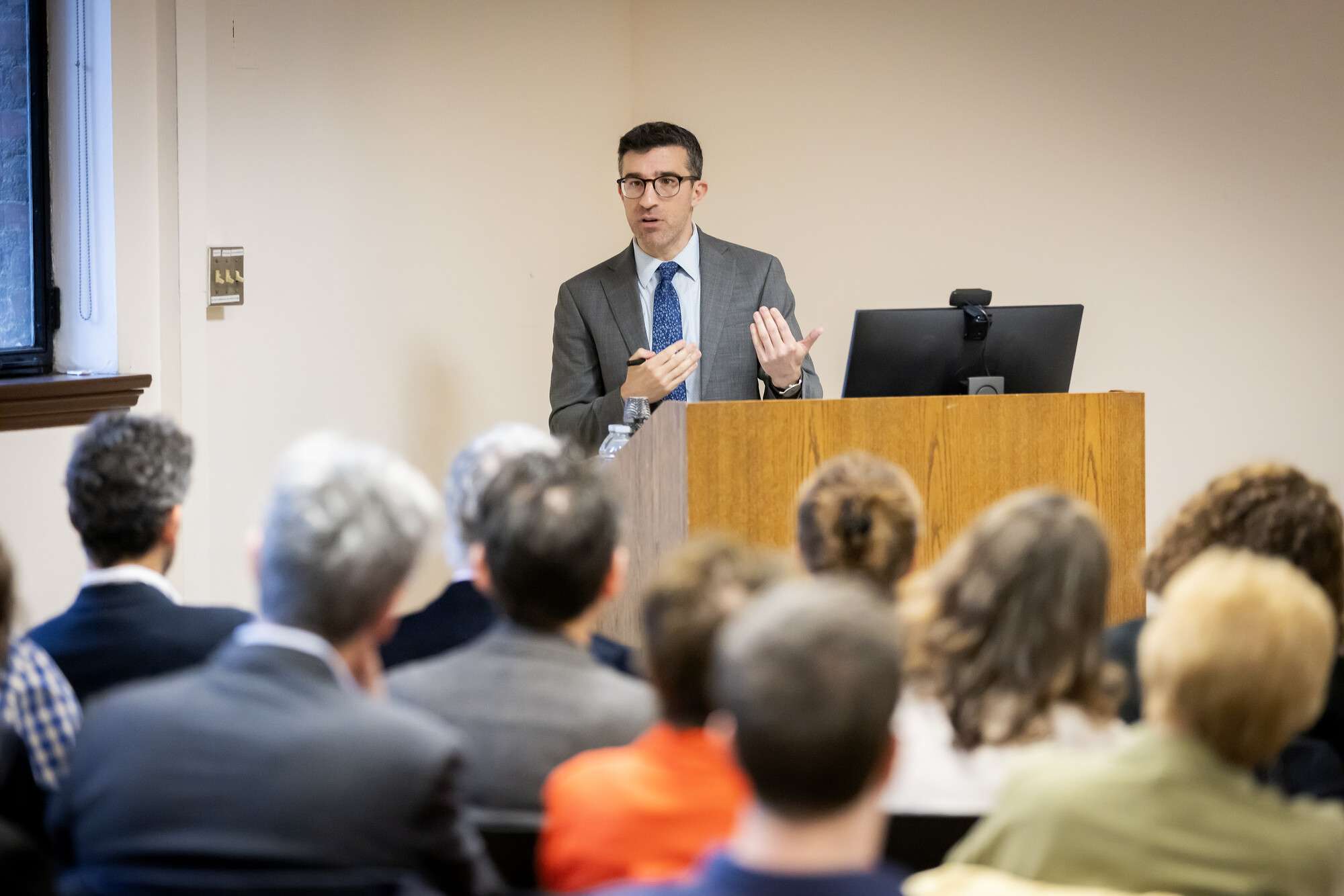 Joshua Teplitsky gesturing at a podium.