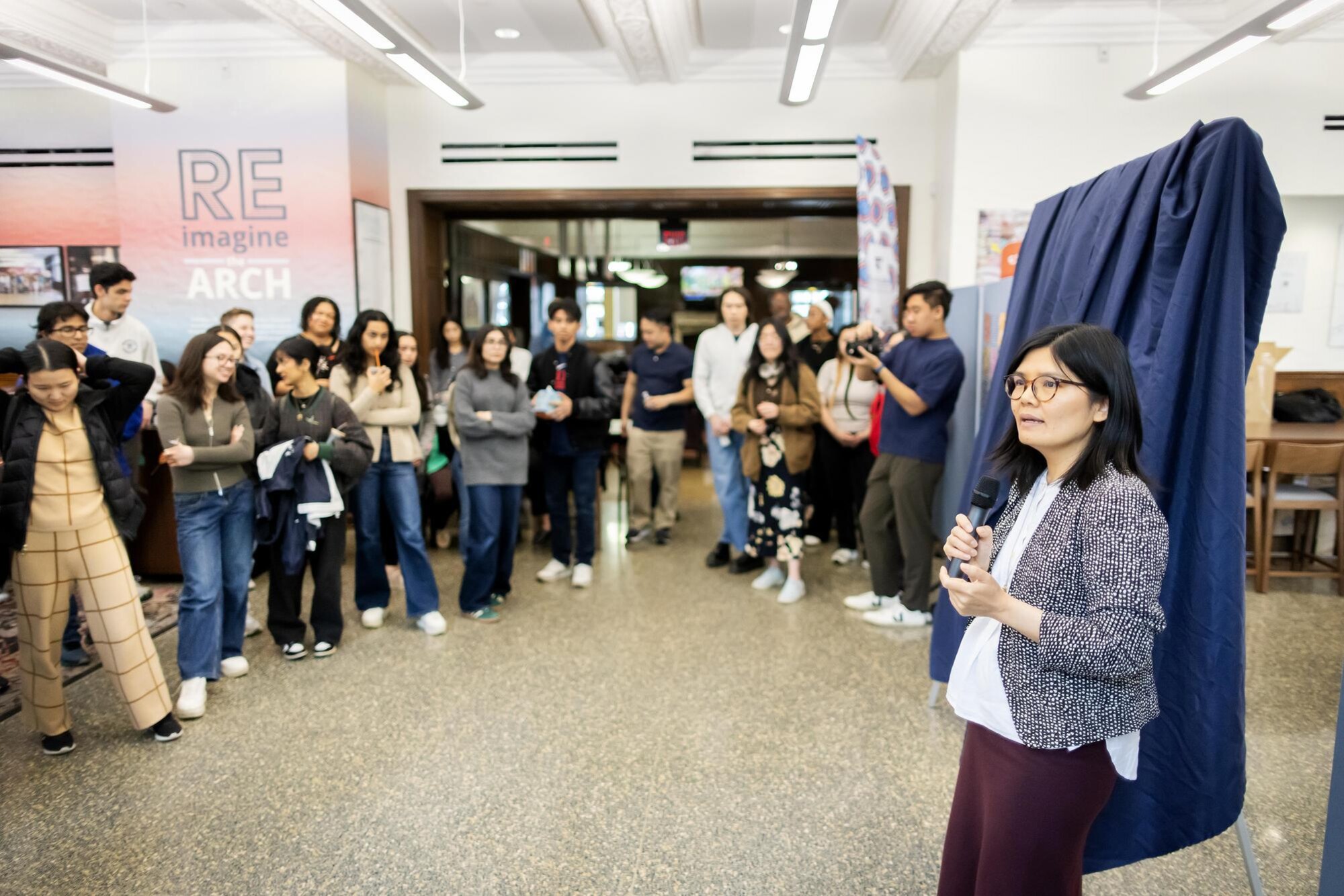 Mei Long speaks at the PAACH mural unveiling in the ARCH building.