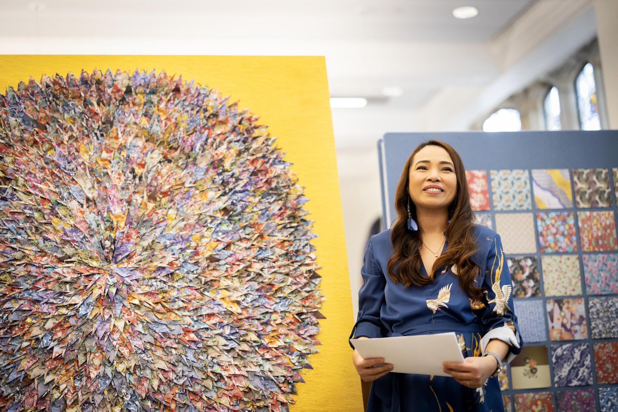 Vicky Aquino stands next to the new PAACH mural unveiled at the ARCH building.