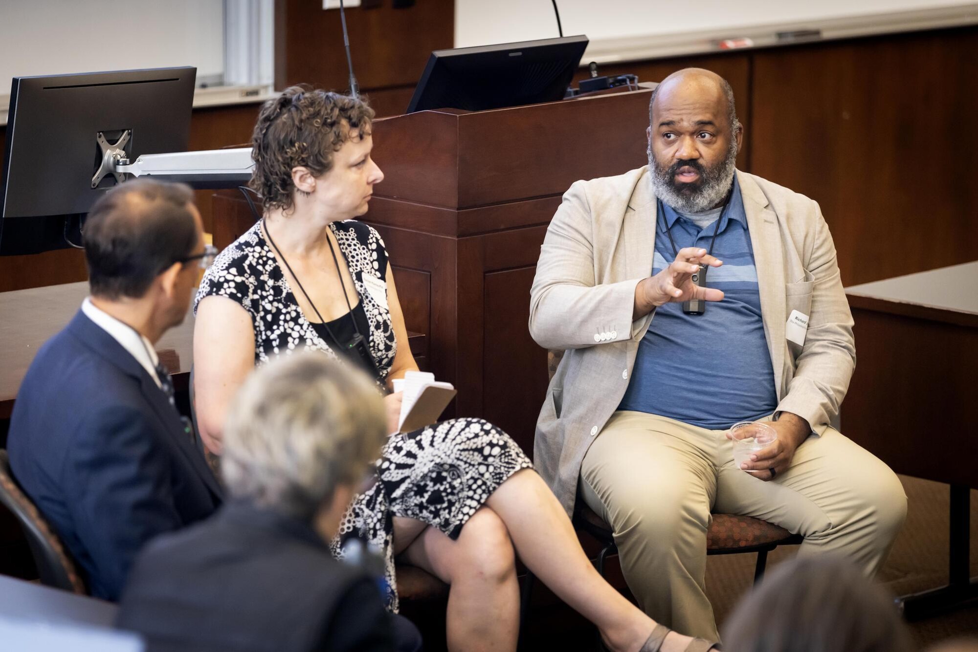 Three people at the UCOMMS op-ed writing workshop.