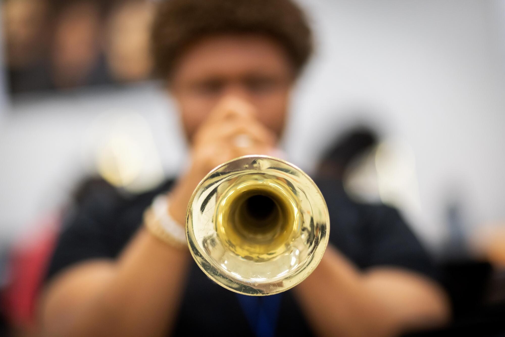 A high school student playing a trumpet in music class.
