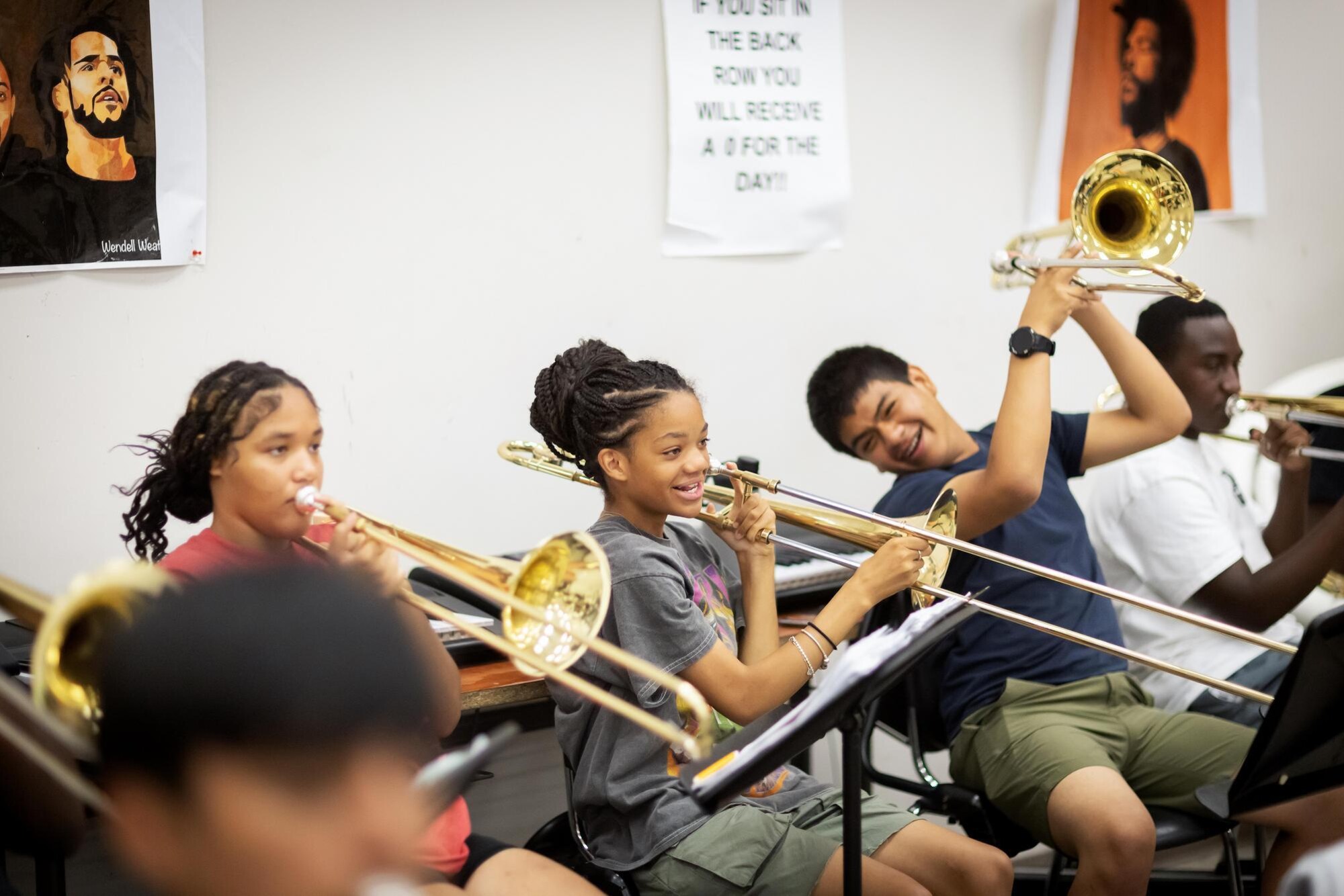 High school students playing musical instruments in music class.