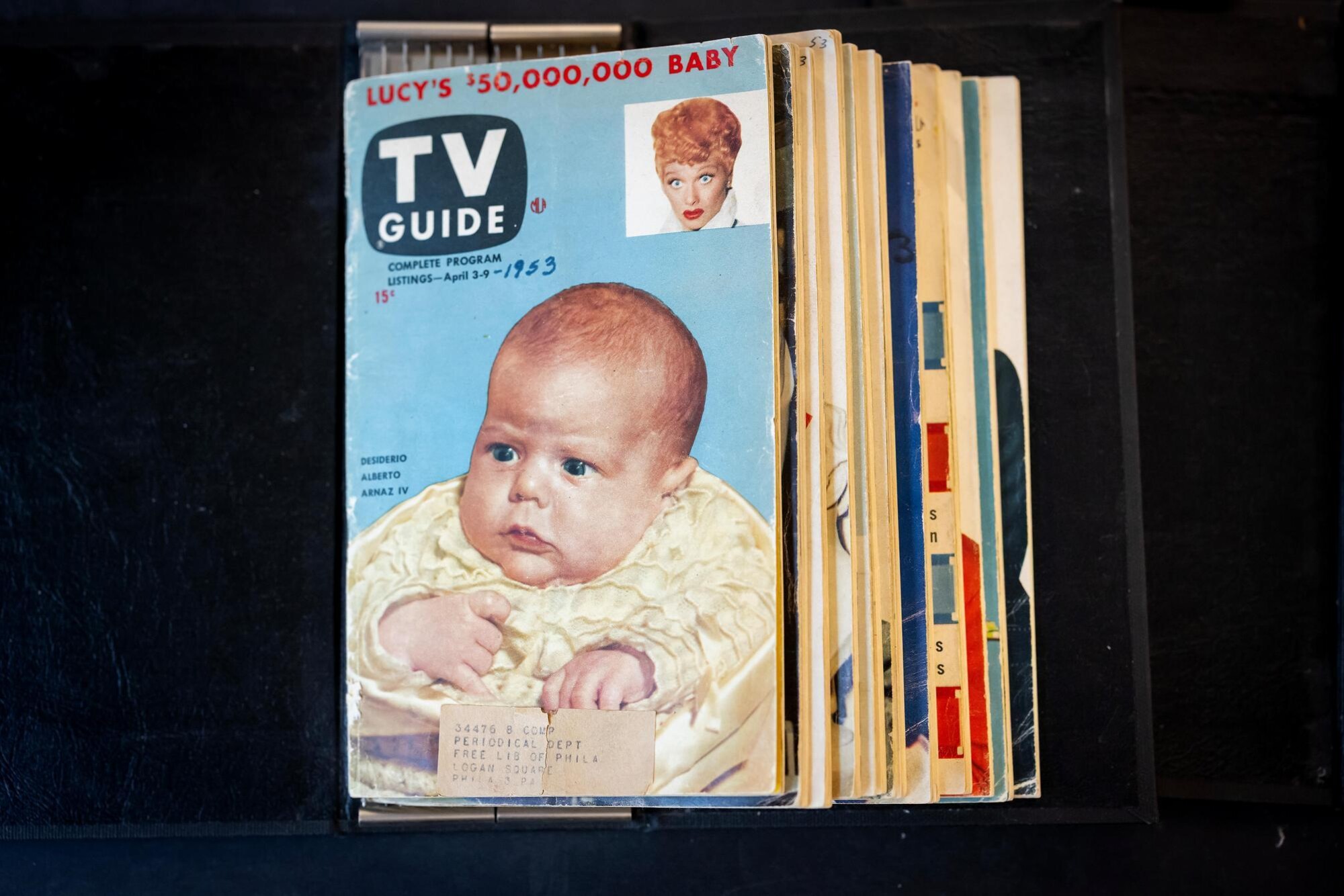 Old TV Guide magazine with a baby and Lucille Ball on the cover.
