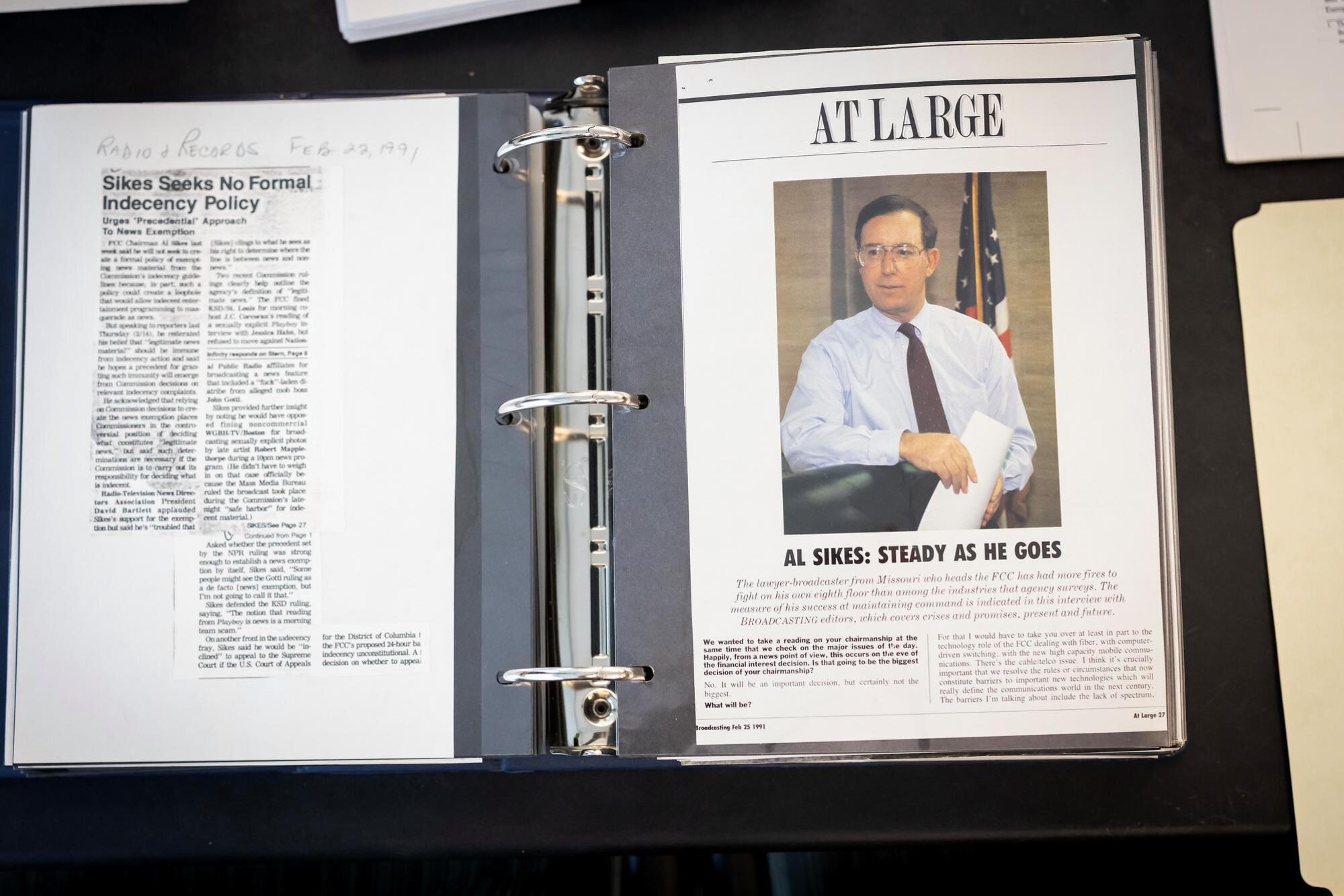 A binder opened to newspaper clippings about Al Sikes.