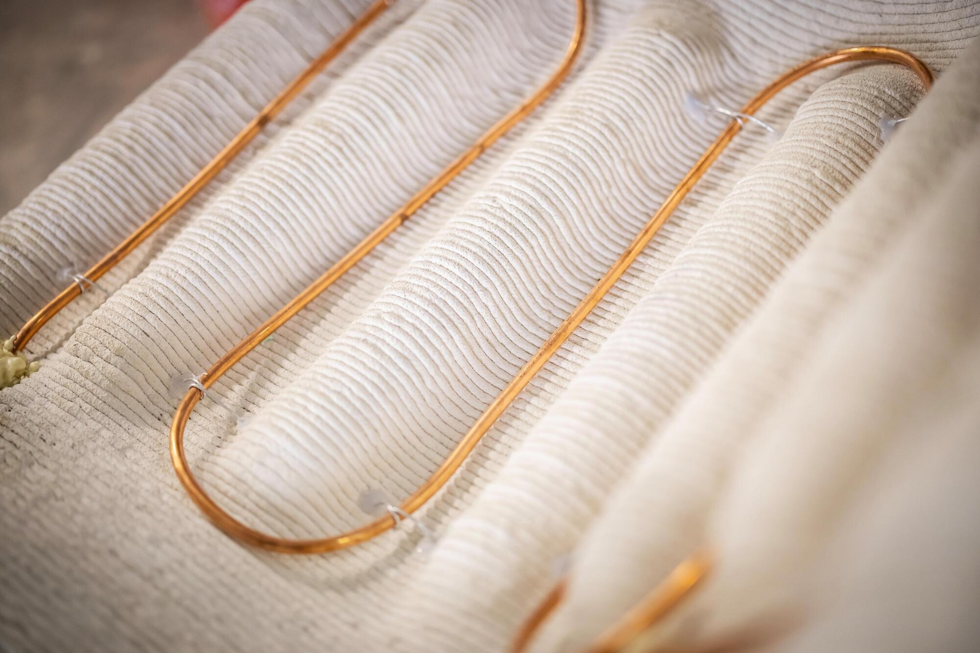 Detail of a copper wire woven into fabric.