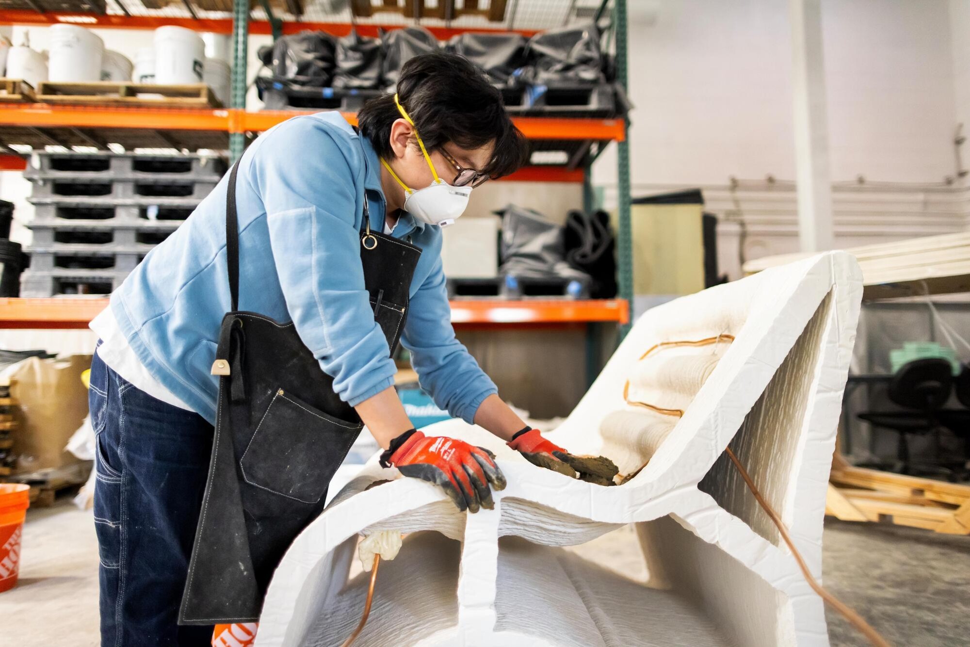 Ph.D. student Ji Yoon Bae casting the top layer of the heating and cooling chair with embedded water pipes. 