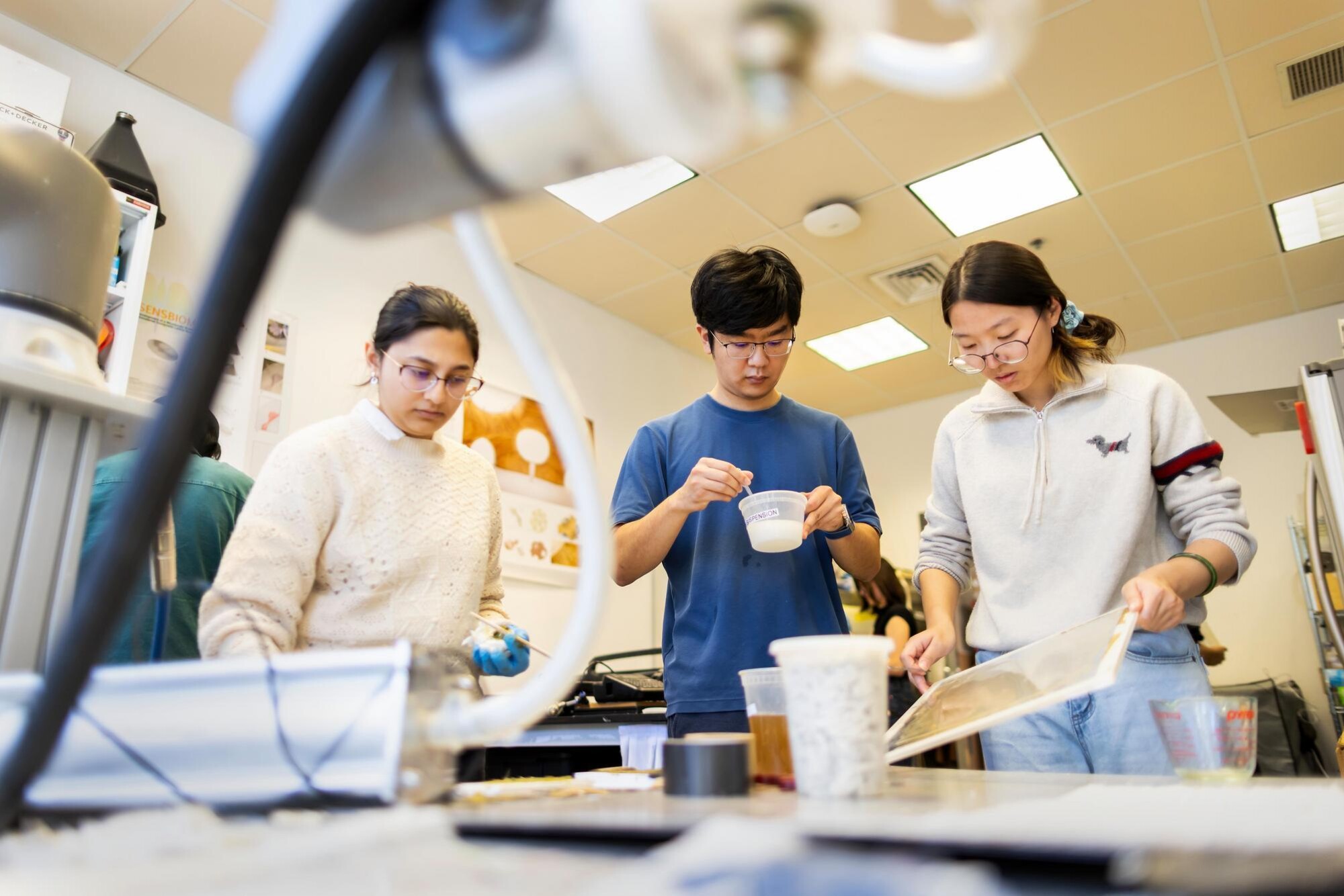 Three students working in the the Dumo Lab.