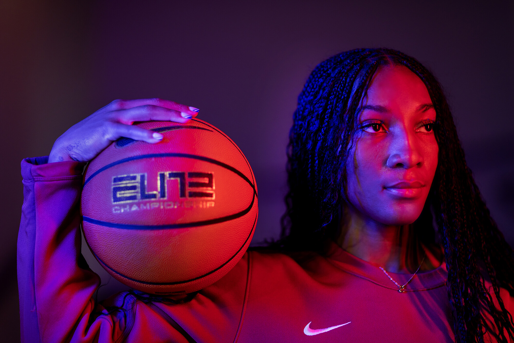 Simone Sawyer holds a basketball on her shoulder.