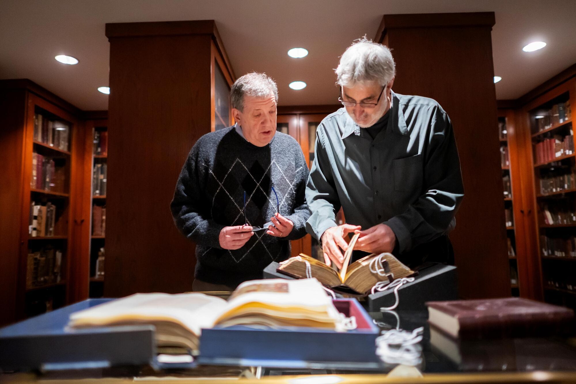 Steven Weitzman (left) looking through library artifacts with Katz Center colleague and Penn’s Judaica collector Arthur Kiron (right)