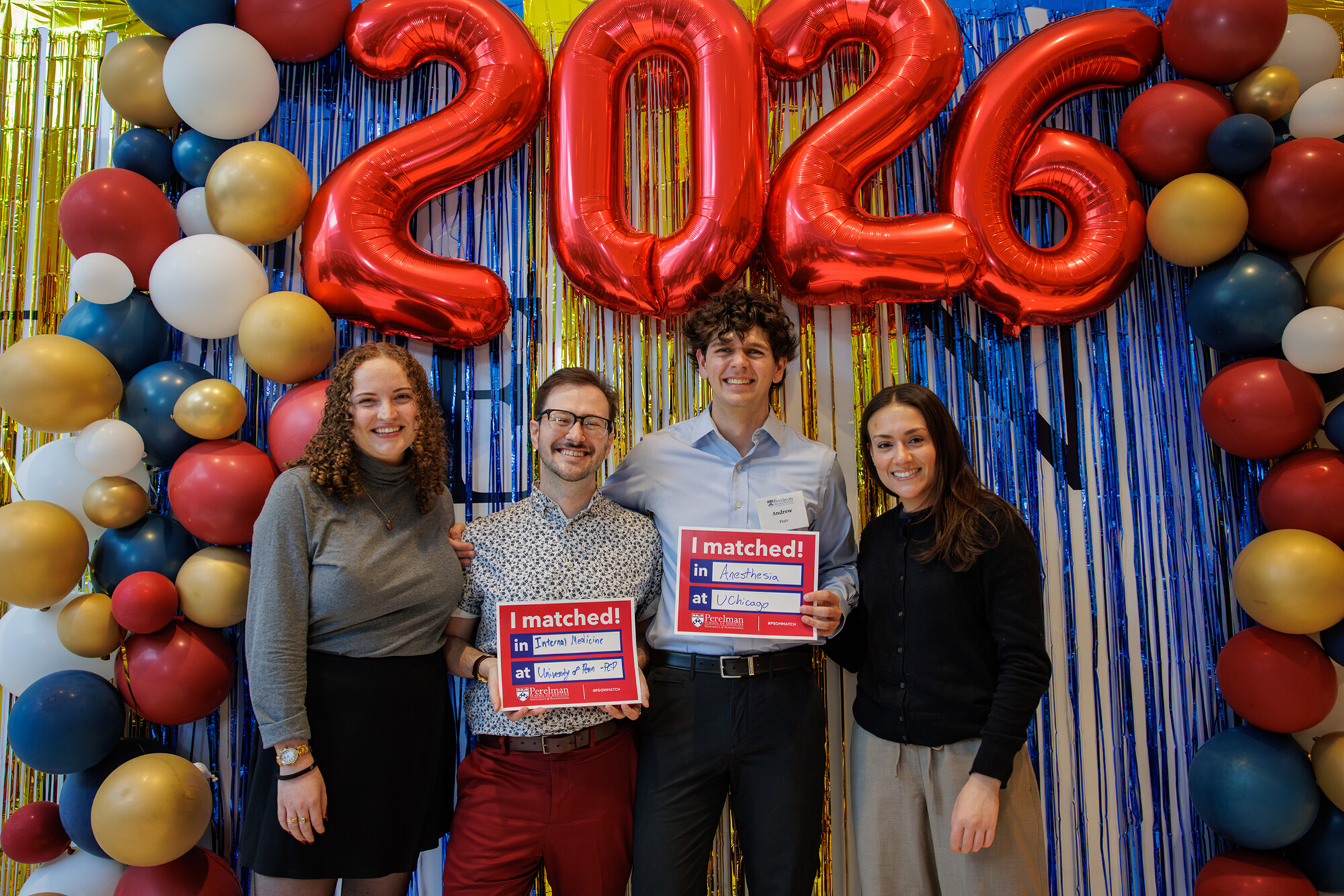 Two Penn Med students and two others under a 2026 balloon at Penn’s 2026 Match Day.