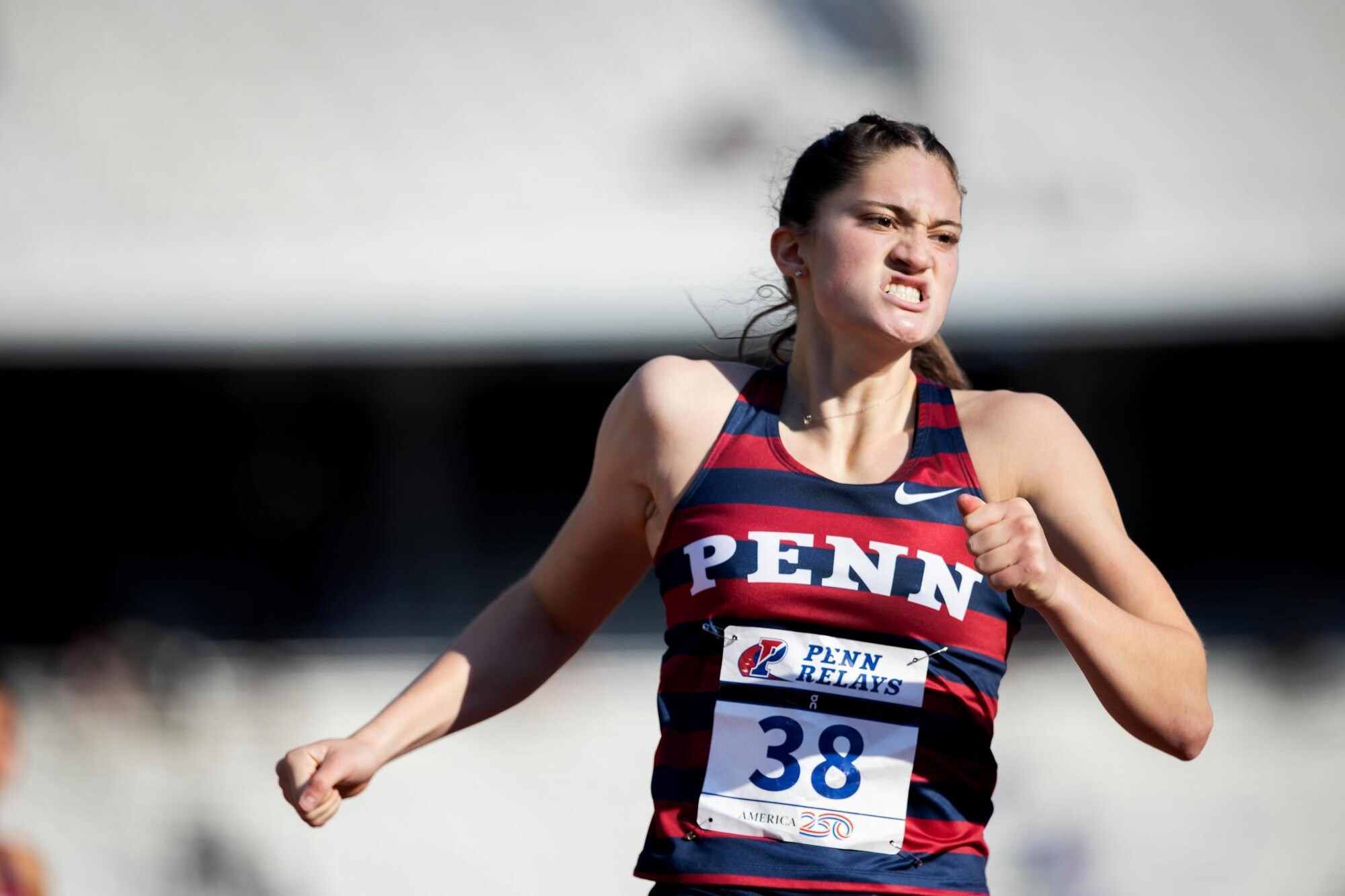 A runner  grimacing at Penn Relays.