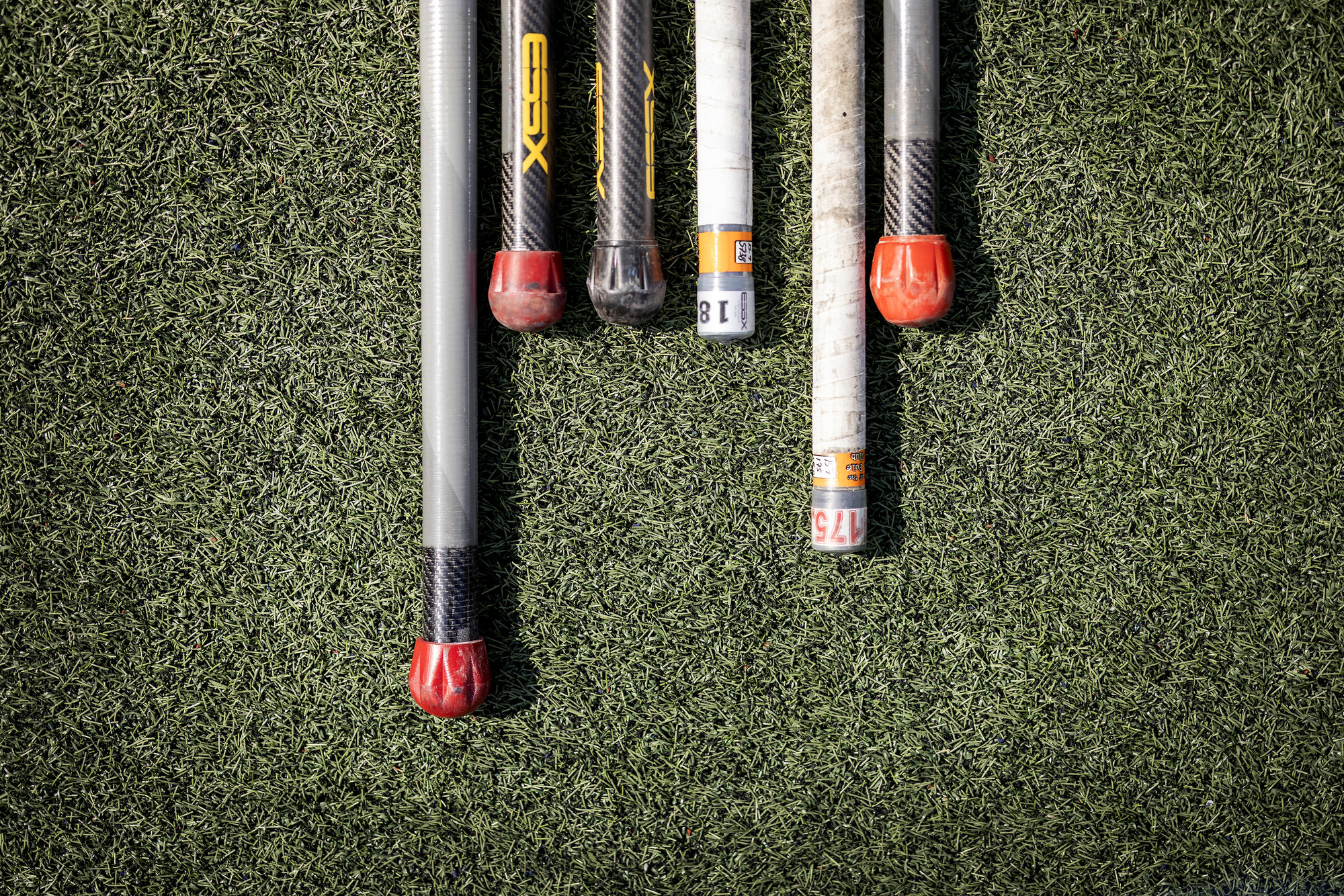 Six pole vault poles on the ground at Franklin Field