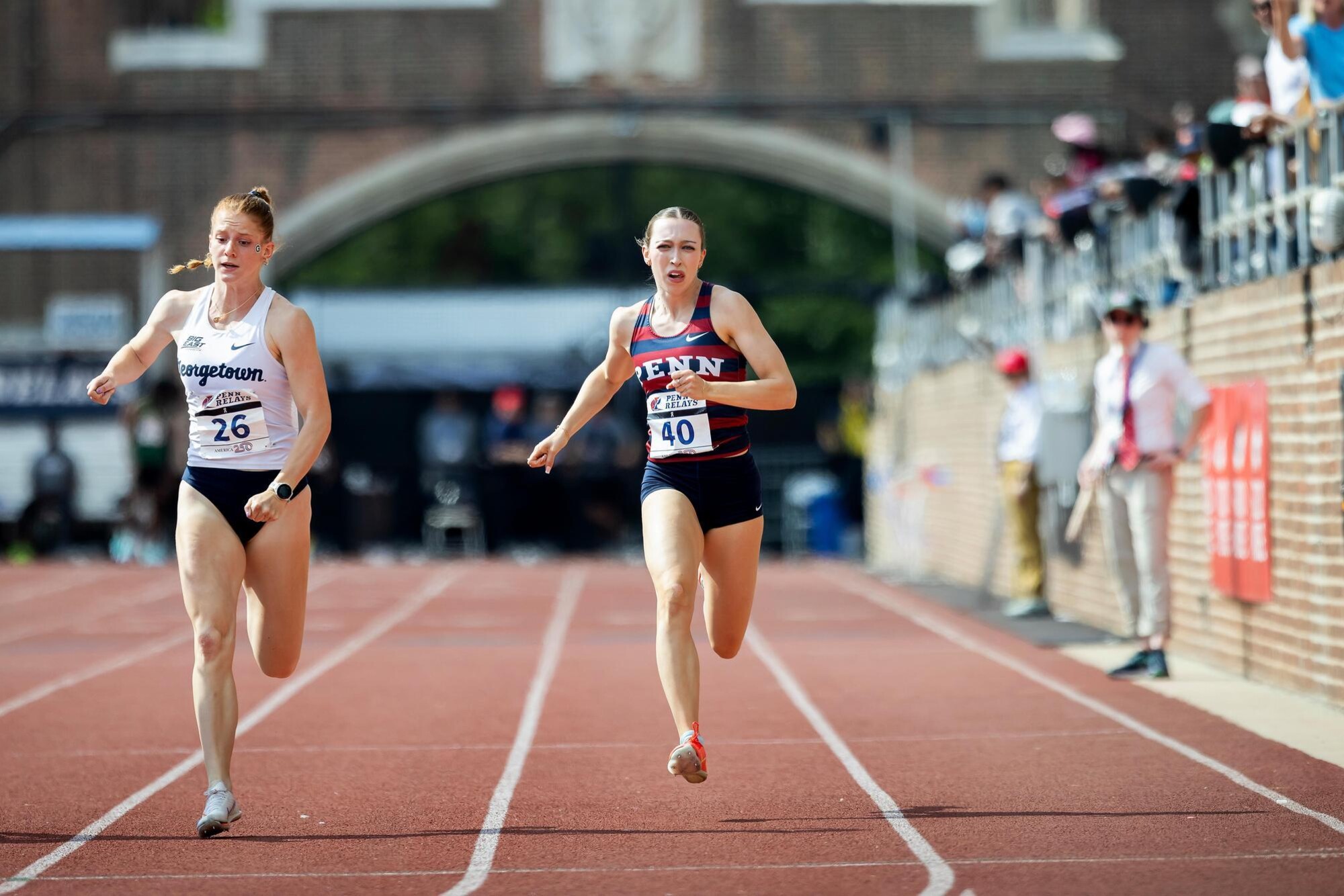 Two runners on the track at Franklin Field.