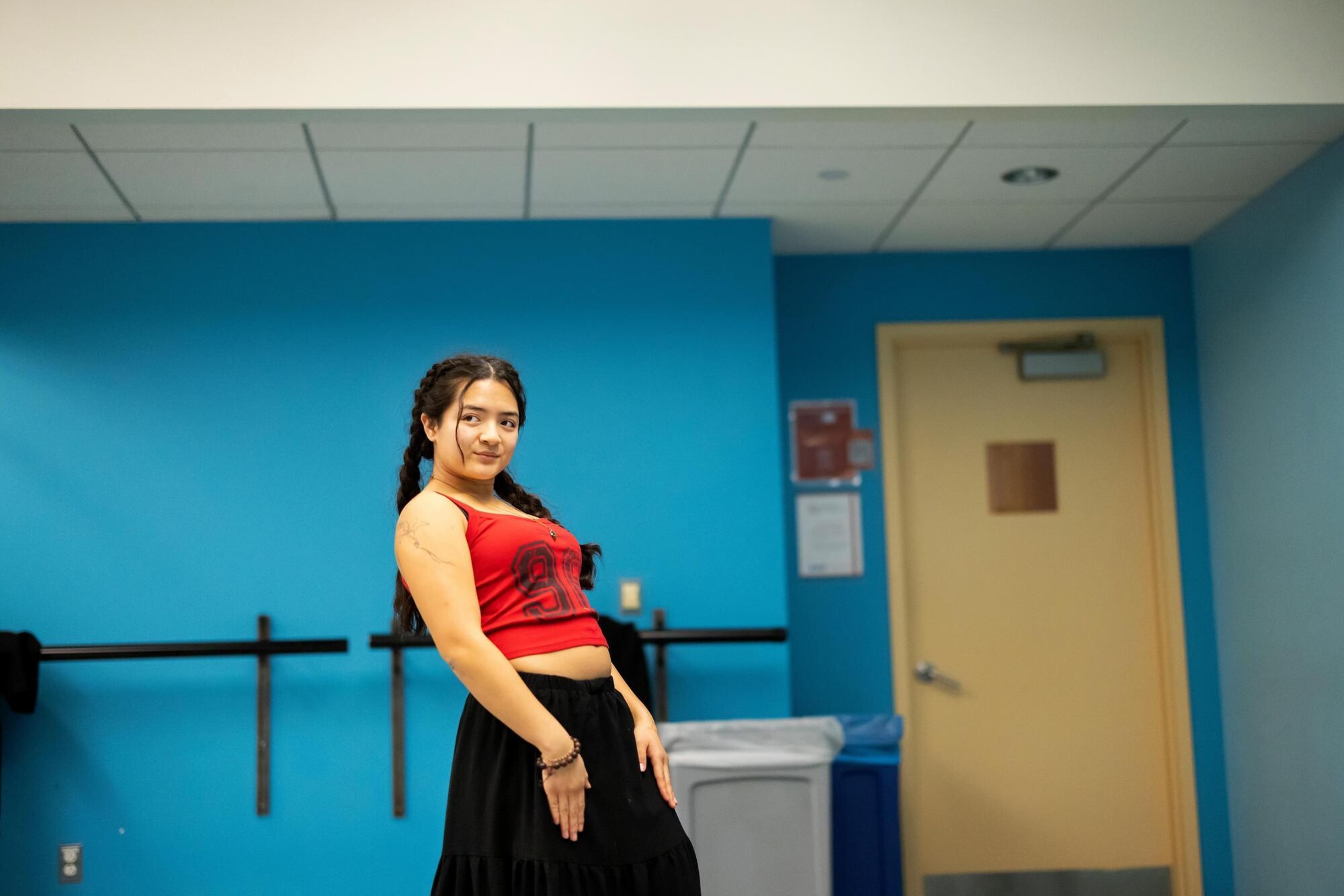 A student in the Onda Latina group striking a sideways pose while practicing their routine.